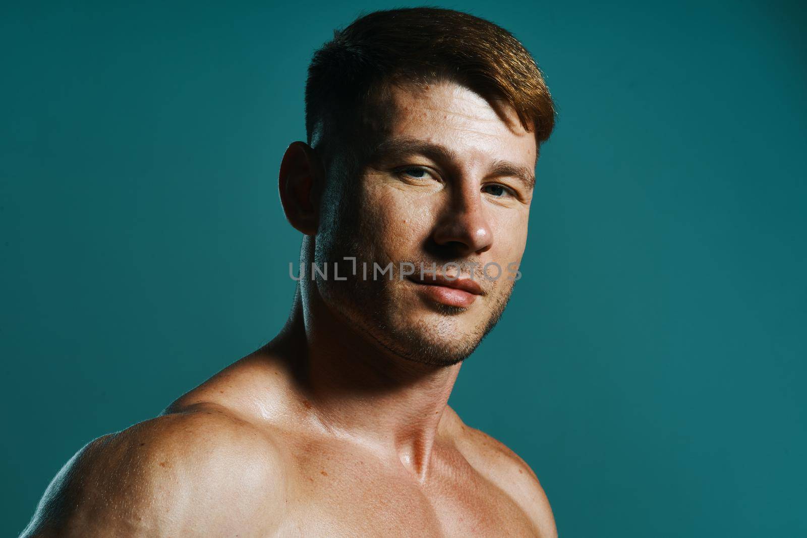 athletic man with pumped up muscular body workout green background. High quality photo