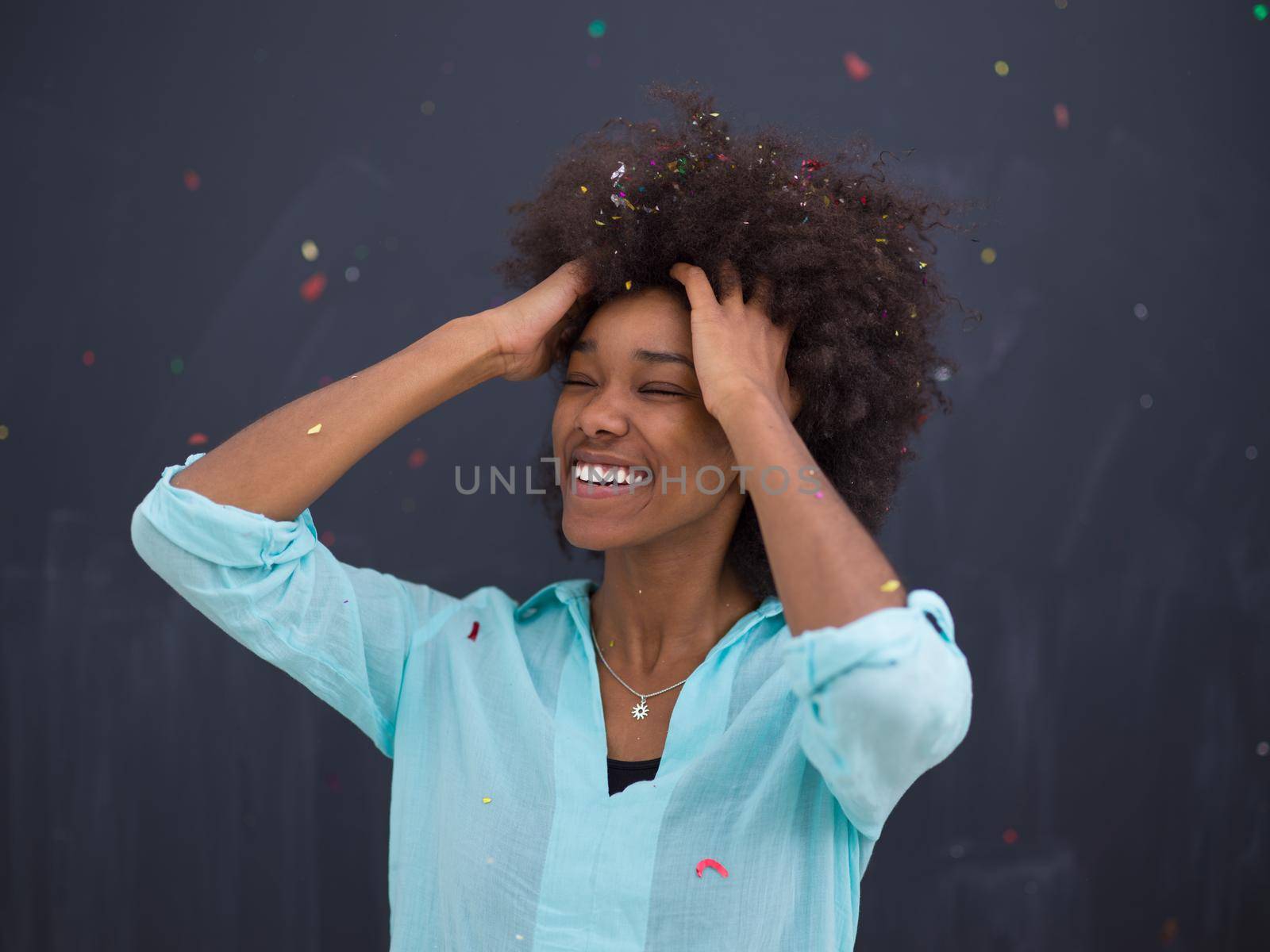 black woman blowing confetti in the air by dotshock