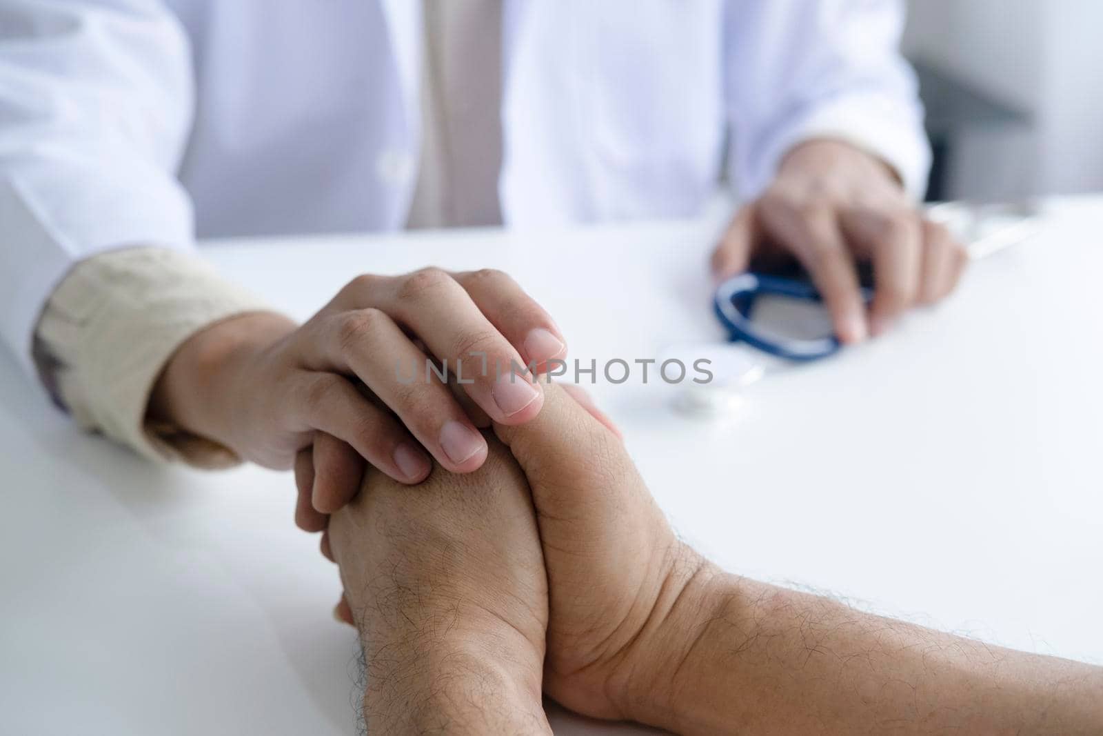 Doctor comforting patient at consulting room
