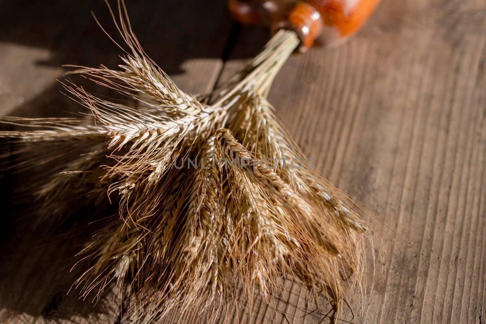 Golden ears of wheat are on the table. The harvest of grain.