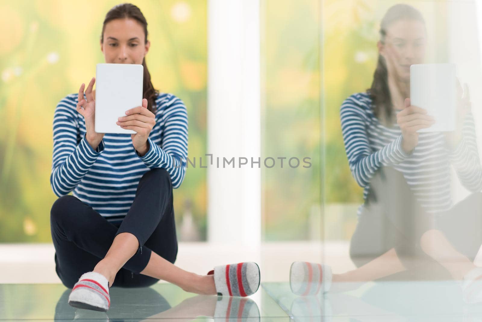beautiful young women using tablet computer on the floor at home