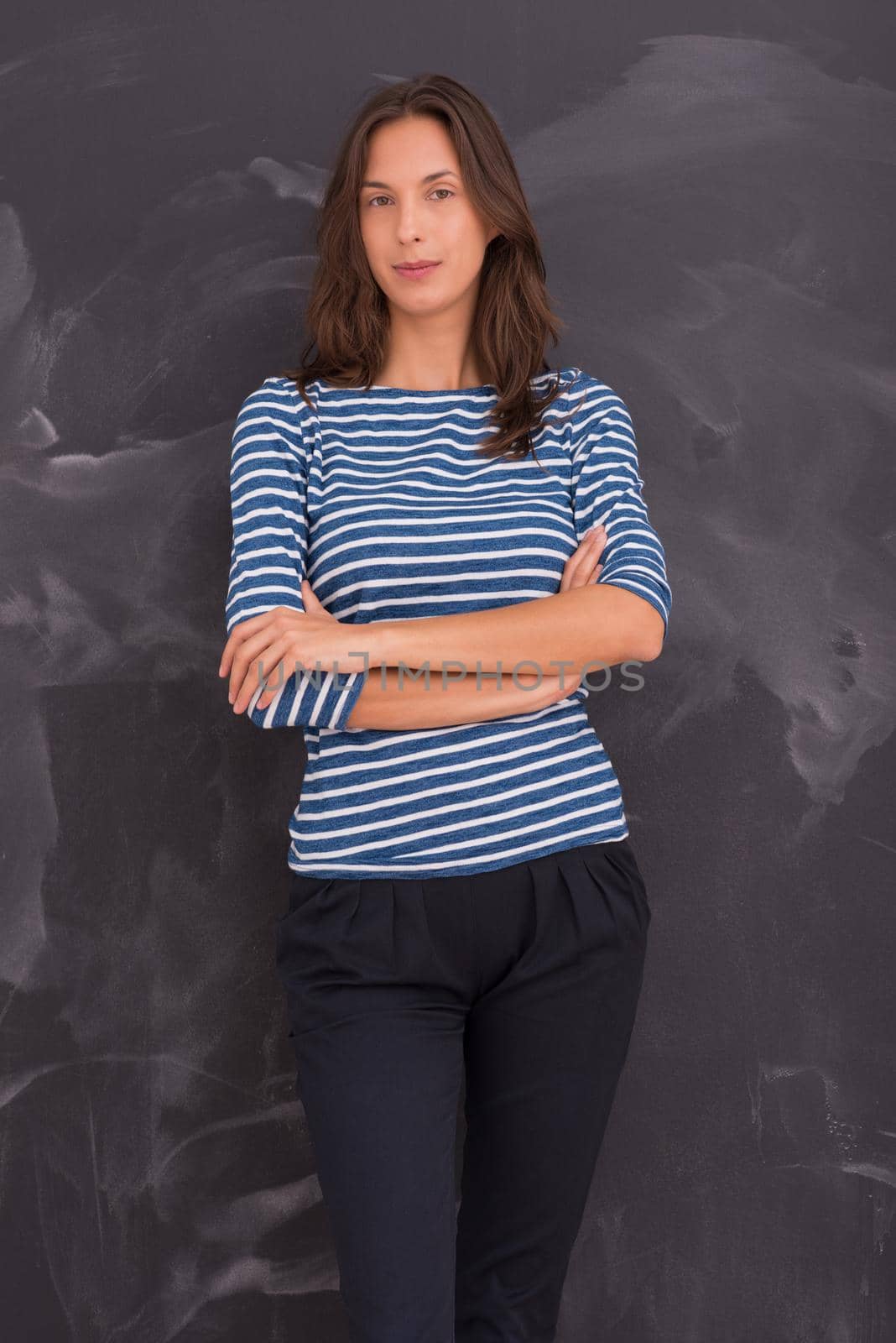 portrait of a young woman standing in front of chalk drawing board