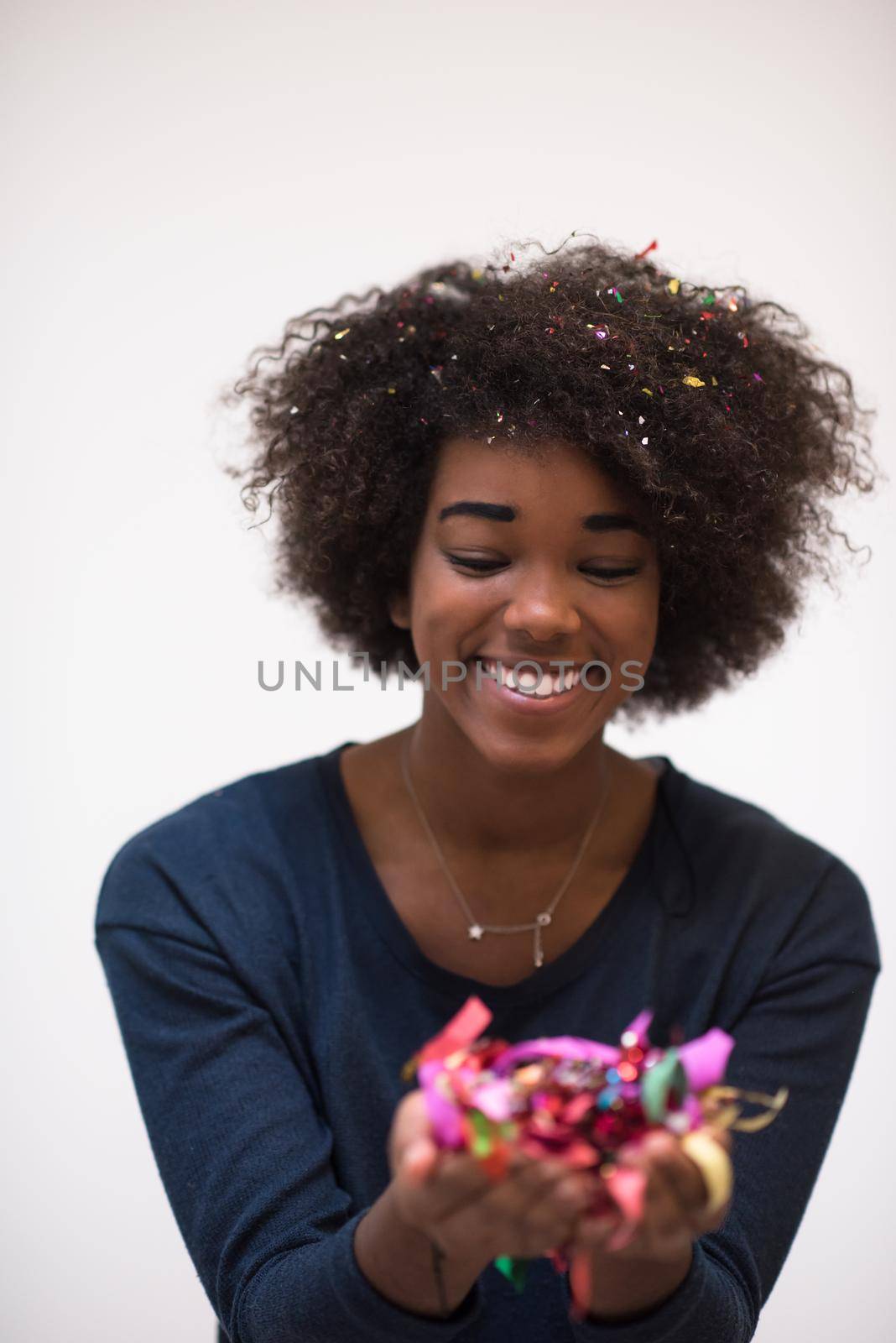 African American woman blowing confetti in the air by dotshock