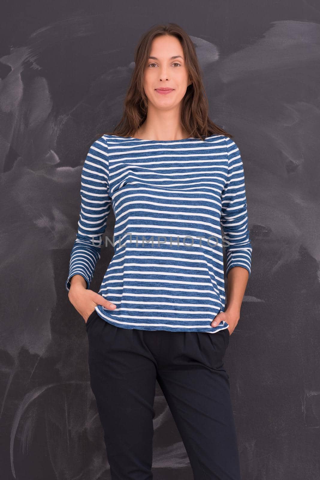 portrait of a young woman standing in front of chalk drawing board