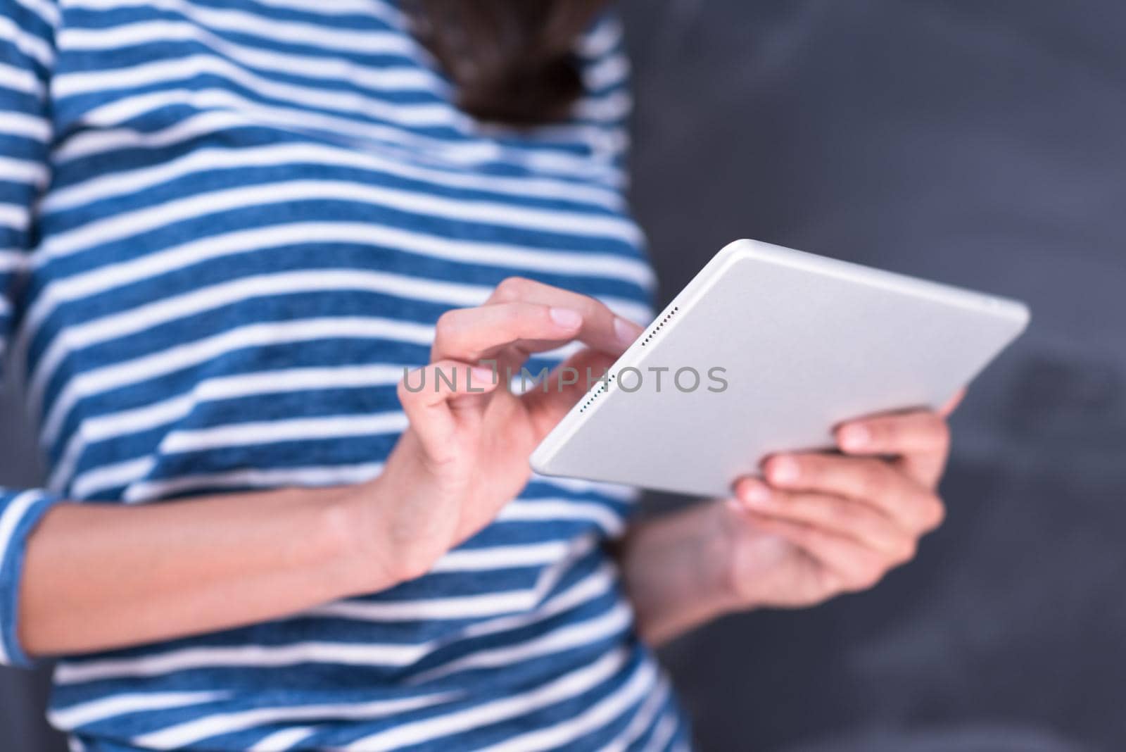 woman using tablet  in front of chalk drawing board by dotshock