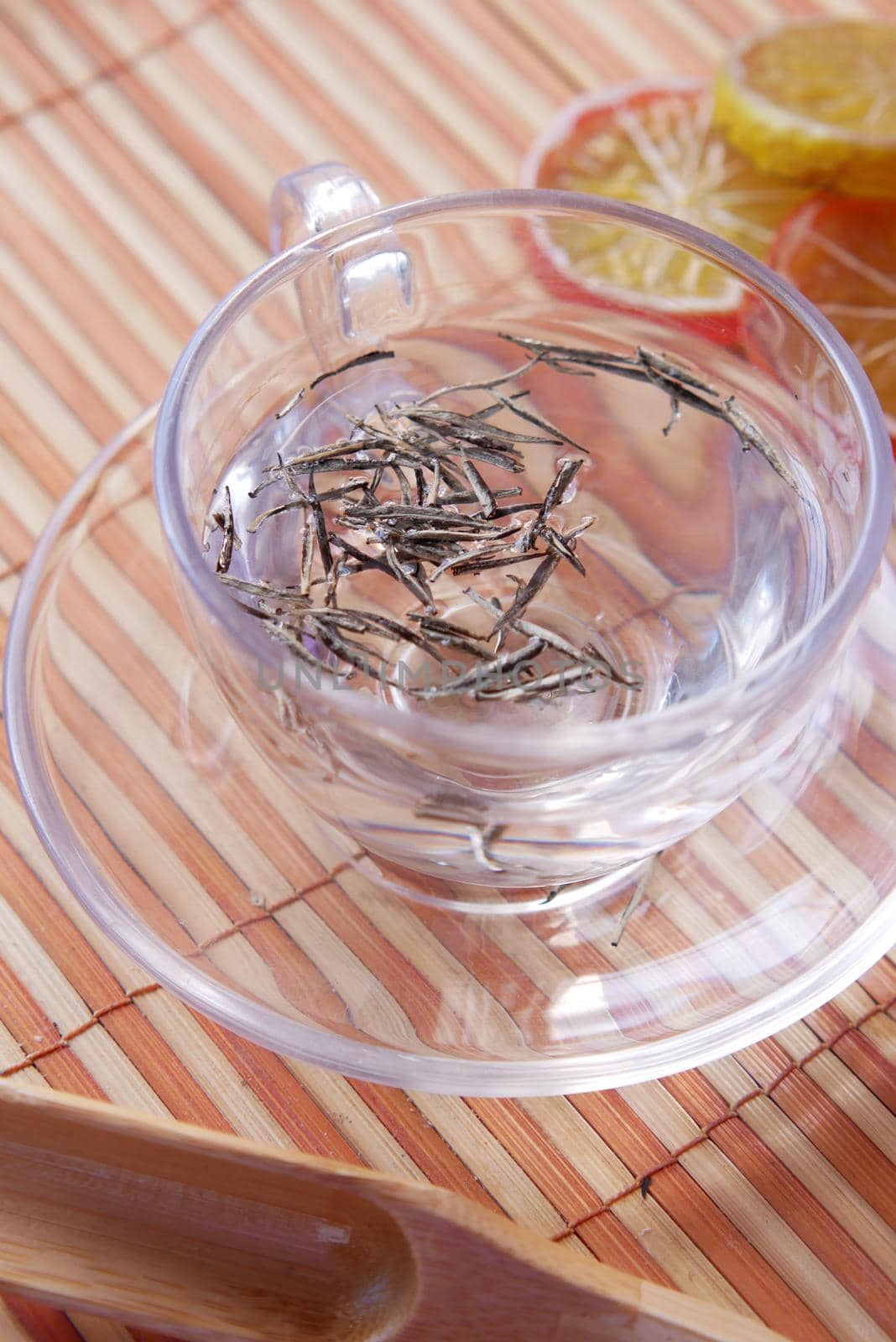 Dry tea leaves on in a tea cup top view .