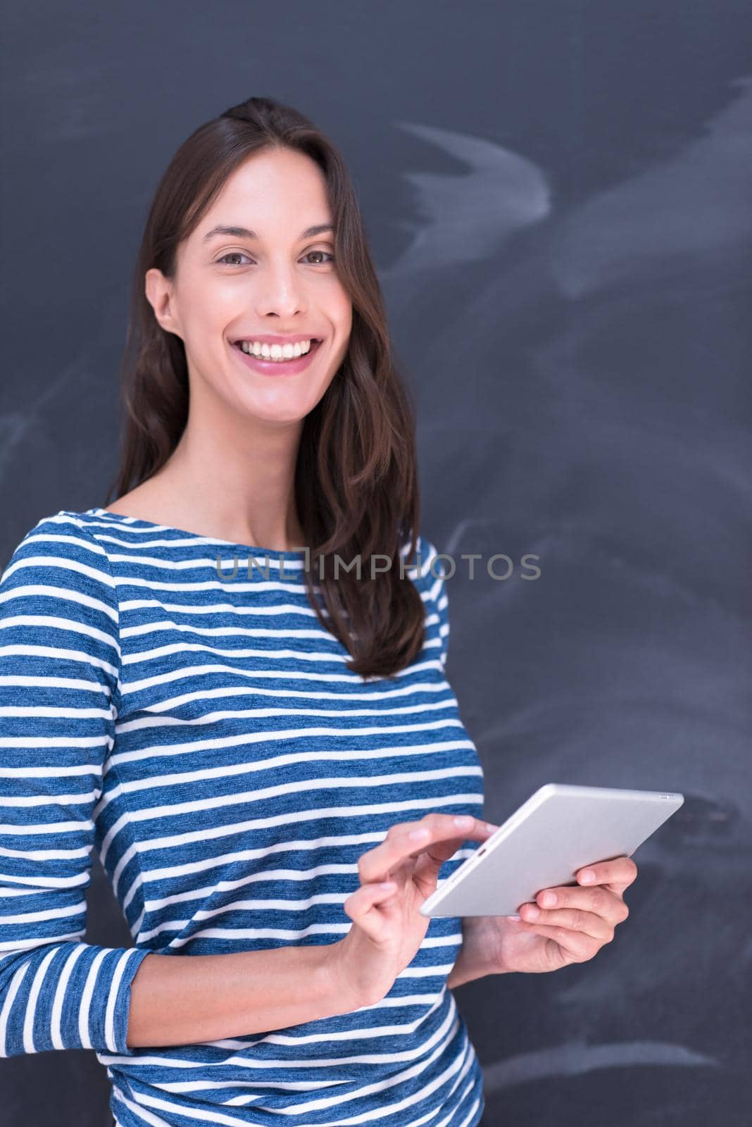 woman using tablet  in front of chalk drawing board by dotshock