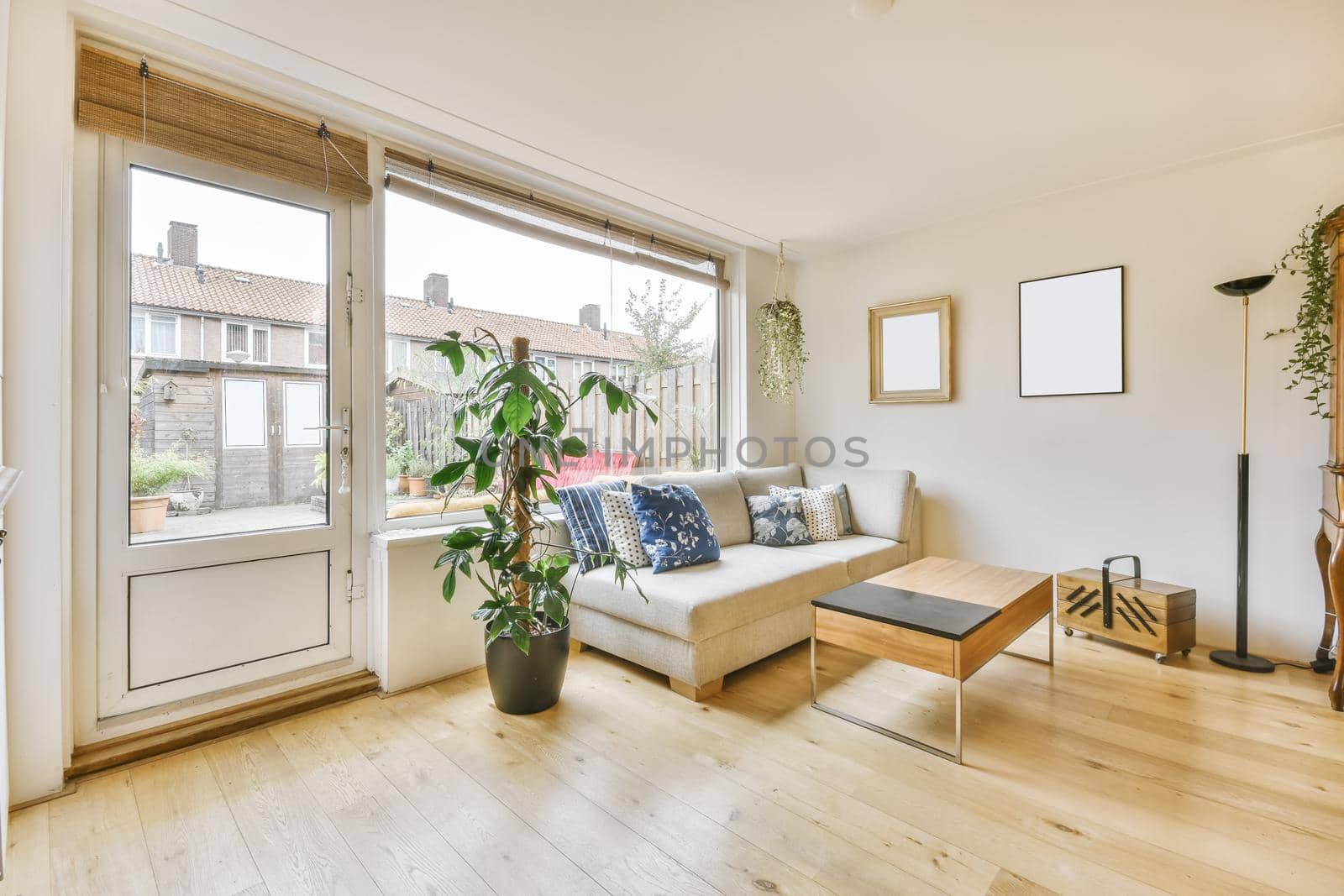 Cozy living area with a soft sofa with pillows and a large window in the back