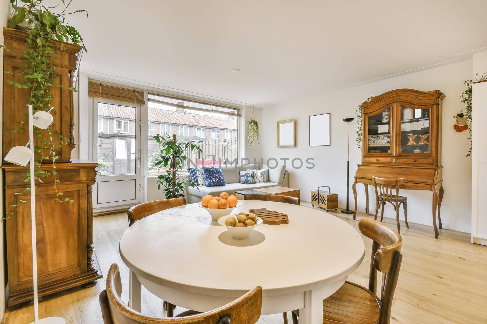 Cozy dining area with round wooden white table and chairs