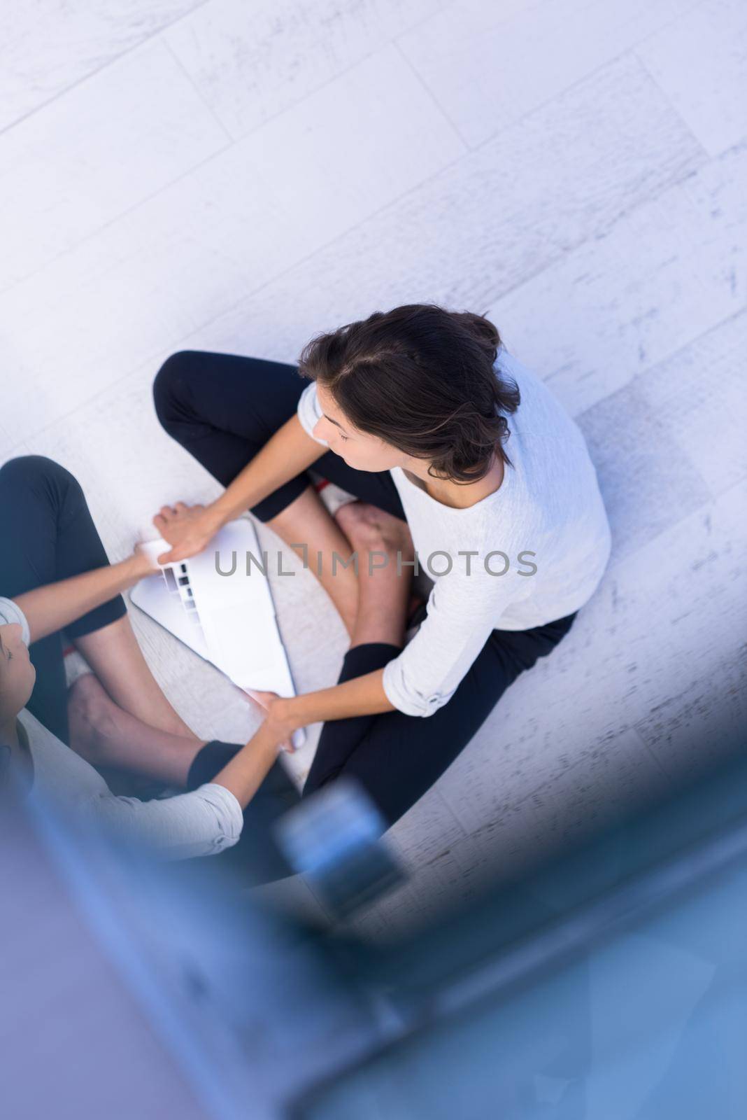 top view of a beautiful young women using laptop computer on the floor at home