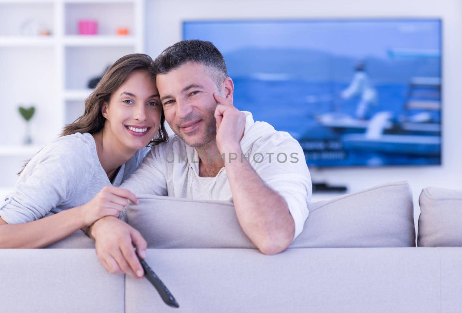 Young couple on the sofa watching television by dotshock