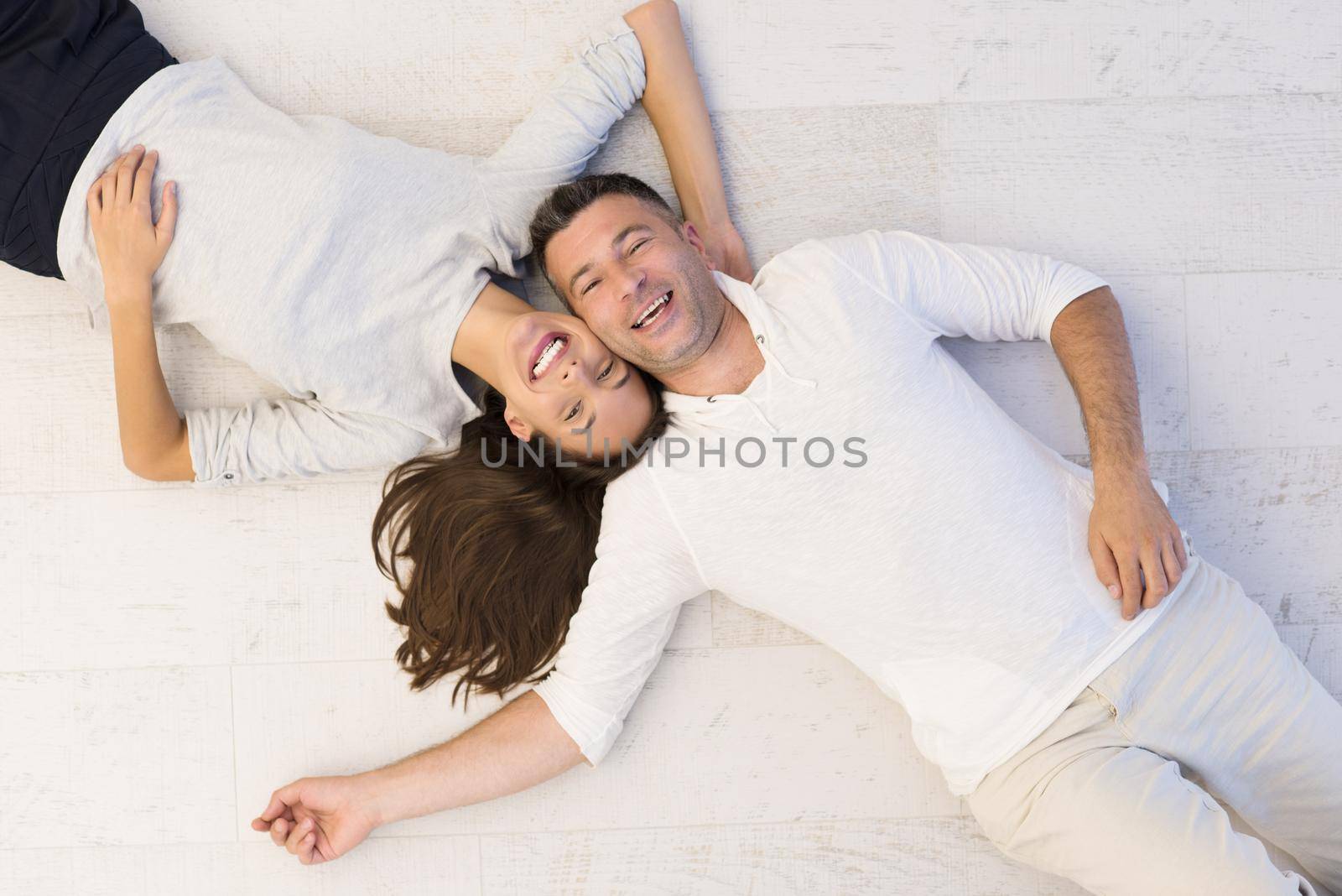 handsome couple lying on floor by dotshock
