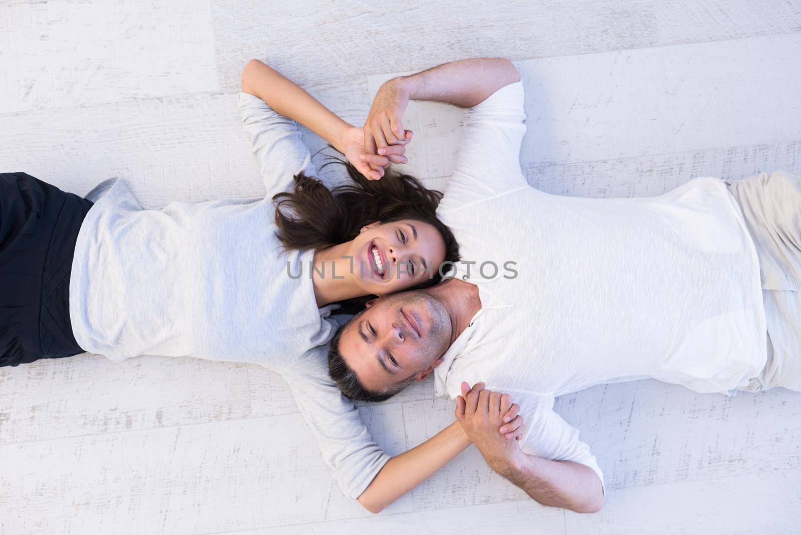 top view of handsome couple lying on floor