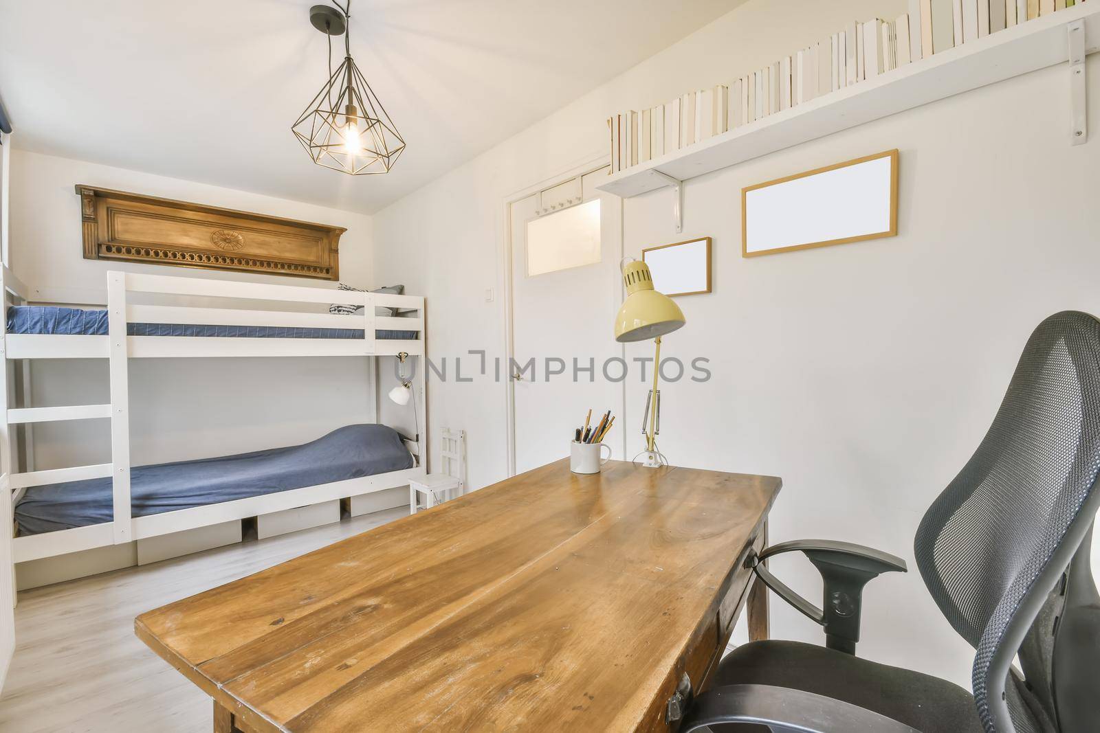 Cozy study area with wooden table and comfortable black chair