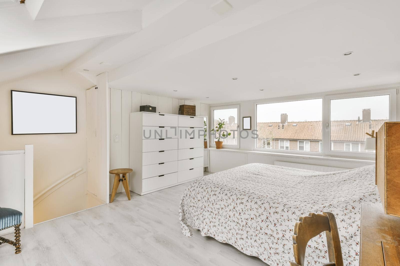 Cozy attic room with a fluffy bed covered with a blanket