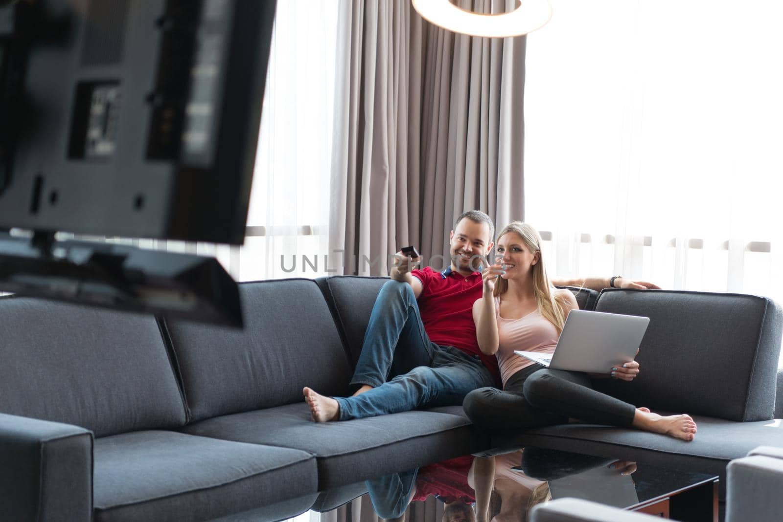 happy couple relaxes in the living room by dotshock