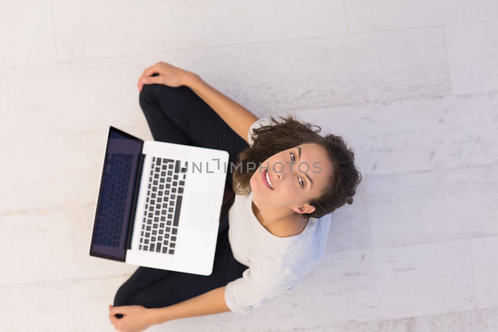 women using laptop computer on the floor top view by dotshock