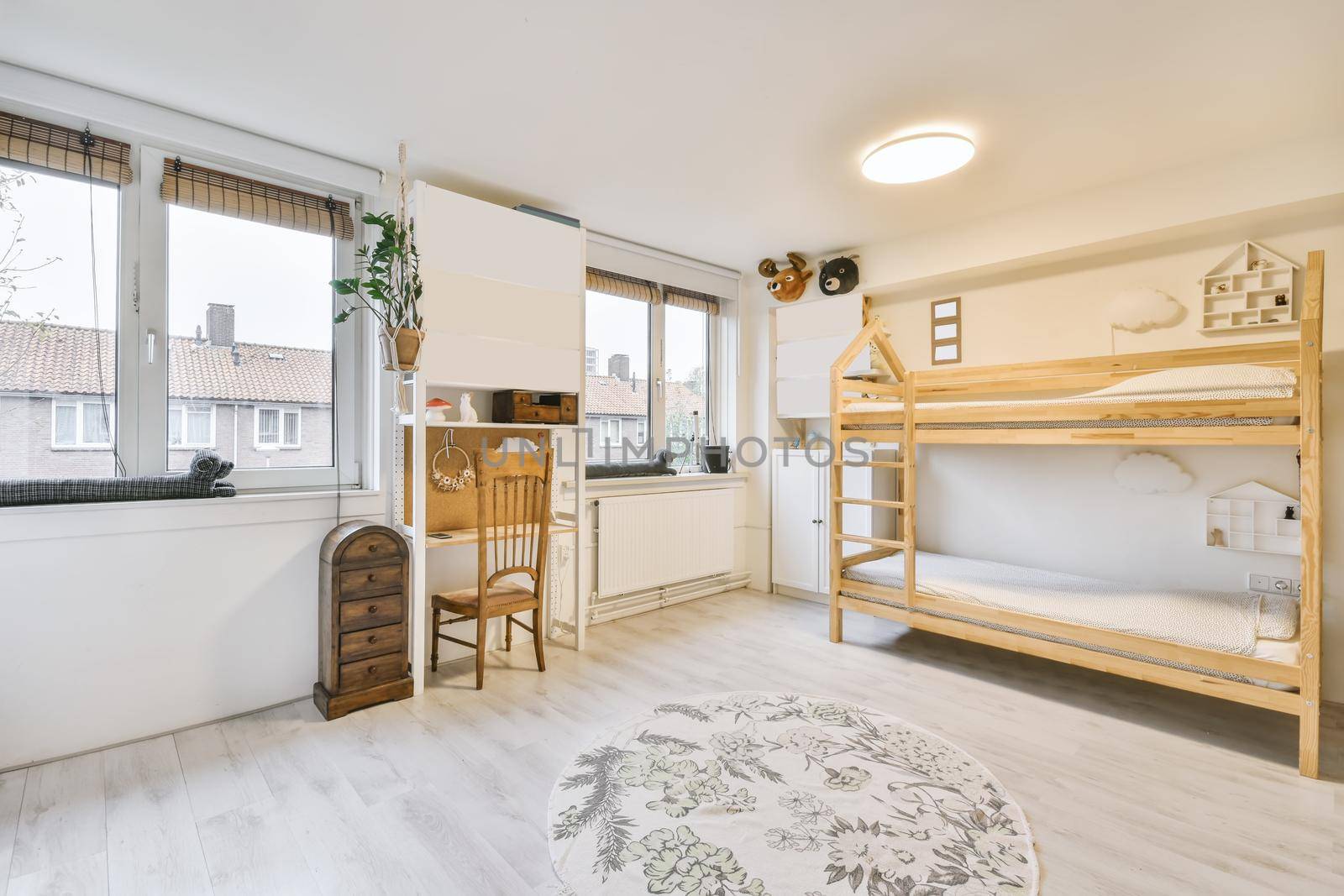 Cozy children's room with a two-story wooden bed and a round rug