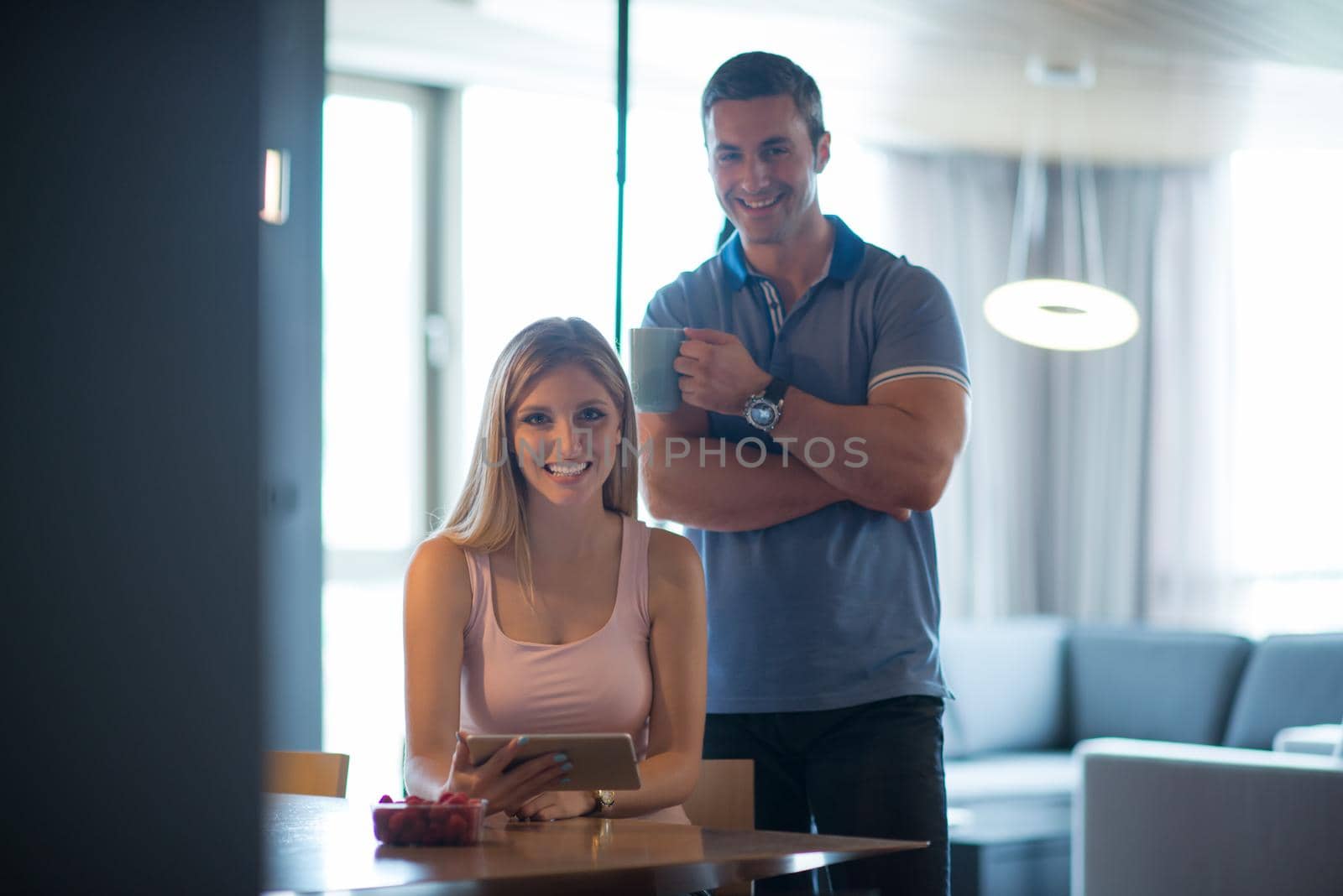 couple using tablet at home by dotshock