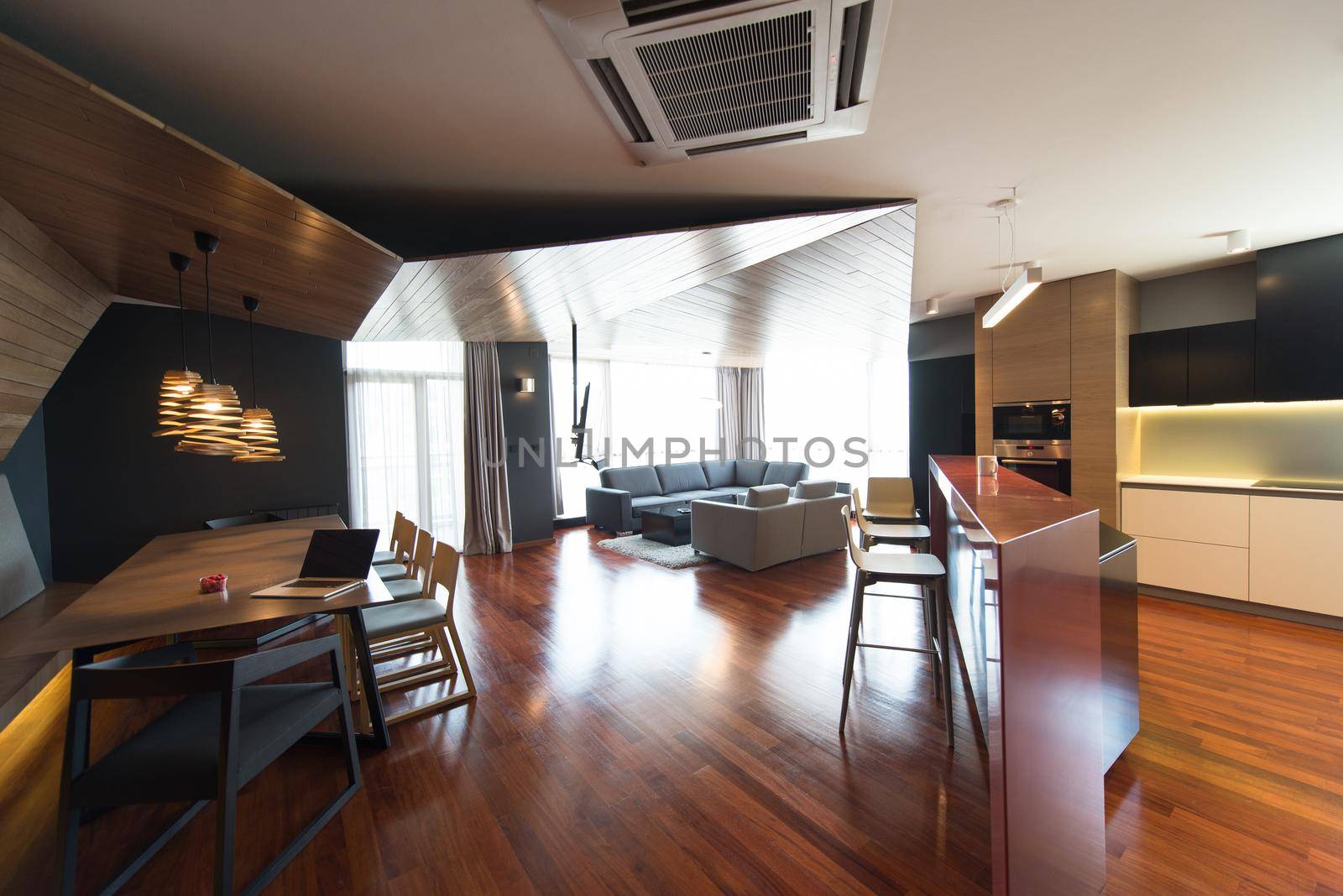 Notebook with blank screen on table in luxury living room.