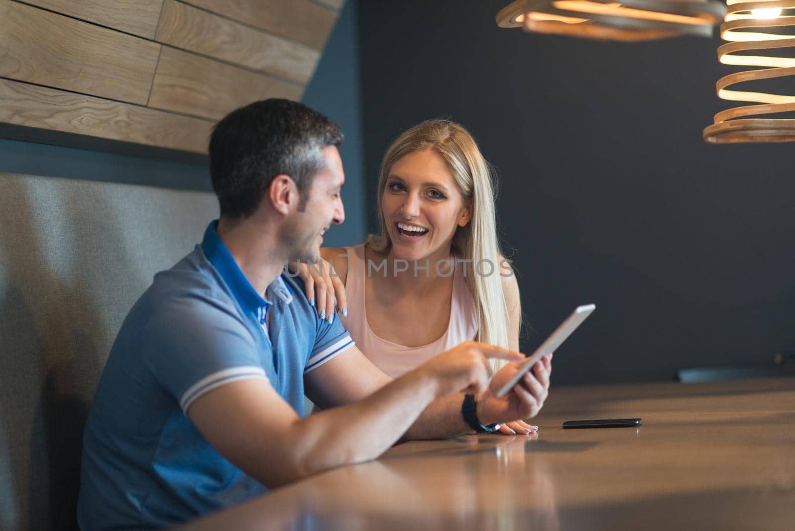 couple using tablet at home by dotshock