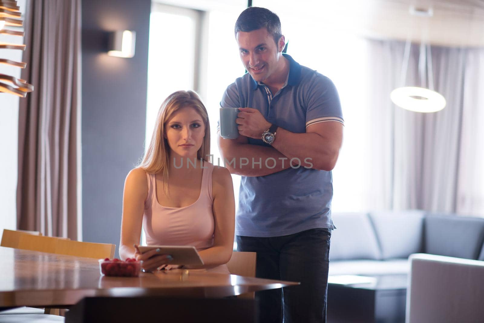 couple using tablet at home by dotshock