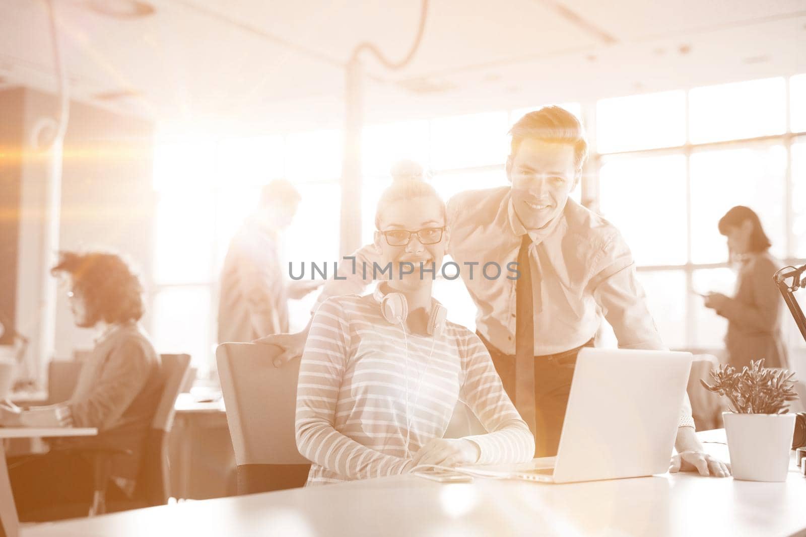 Young businessman helping his colleague at the work by dotshock