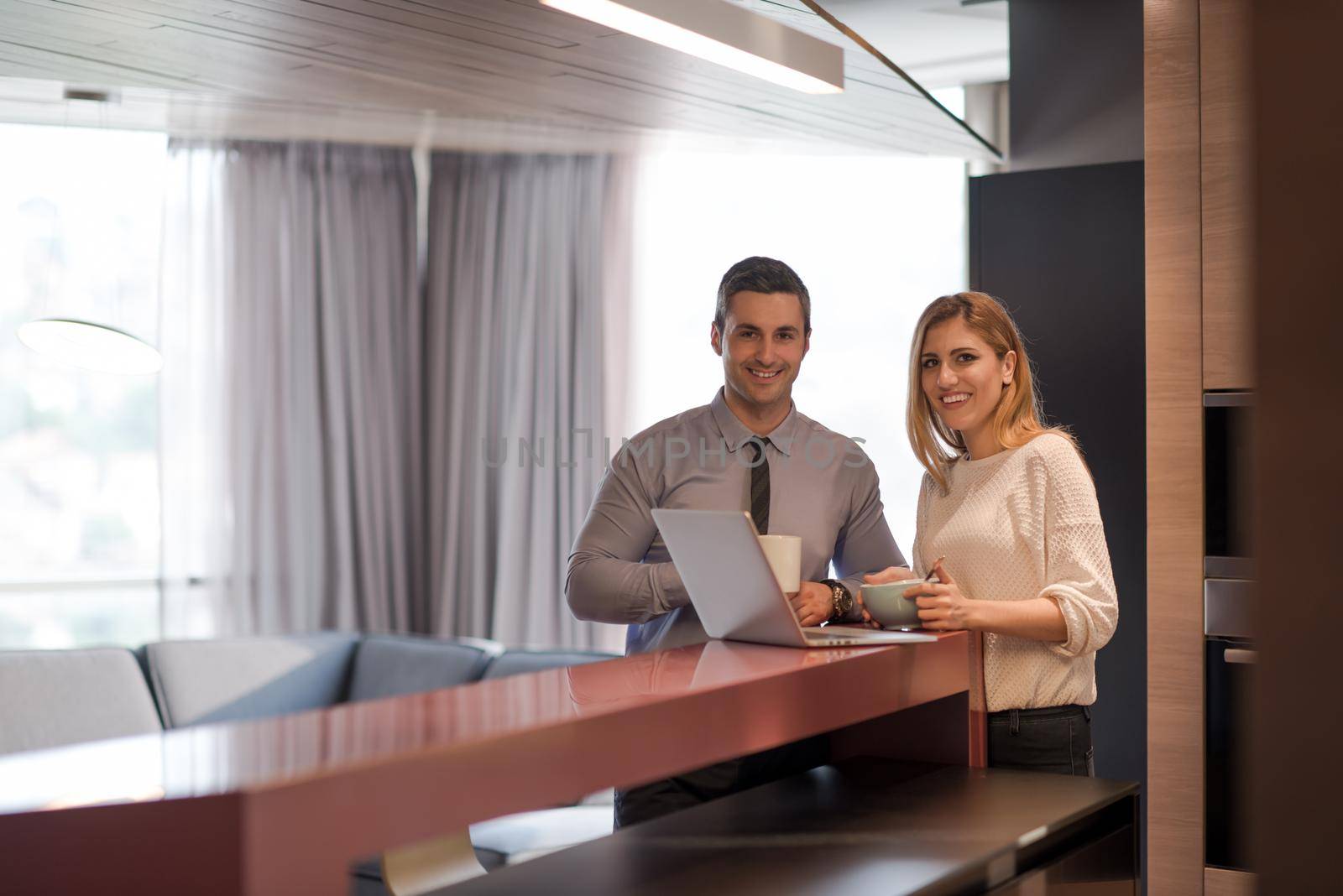 A young couple is preparing for a job and using a laptop by dotshock