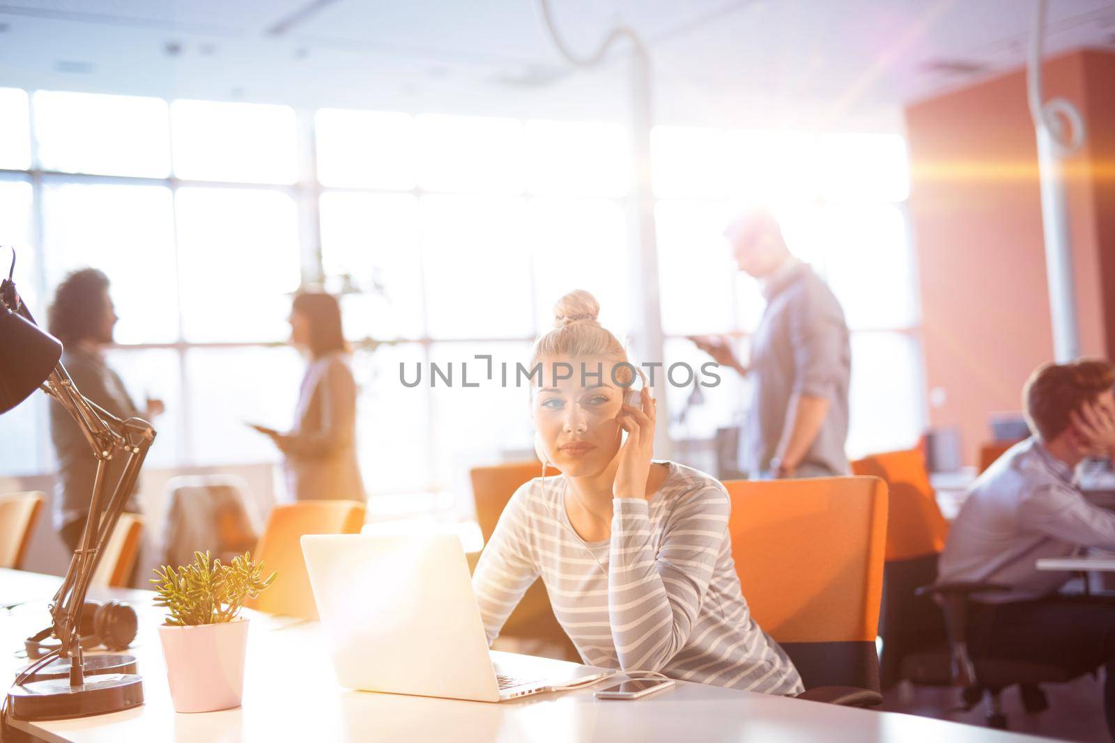Young businesswoman using computer at work by dotshock