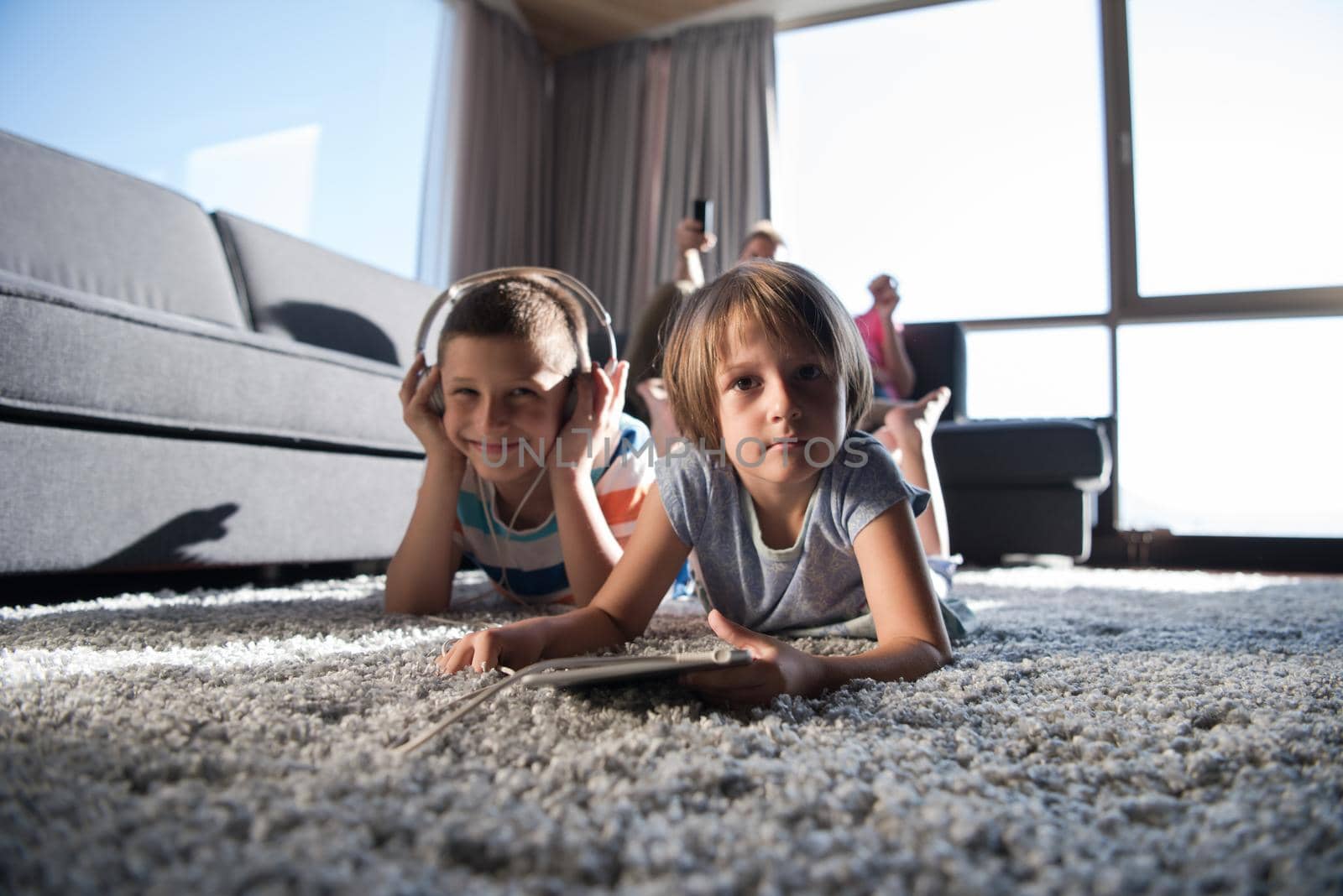 Happy Young Family Playing Together at home.kids using tablet on the floor