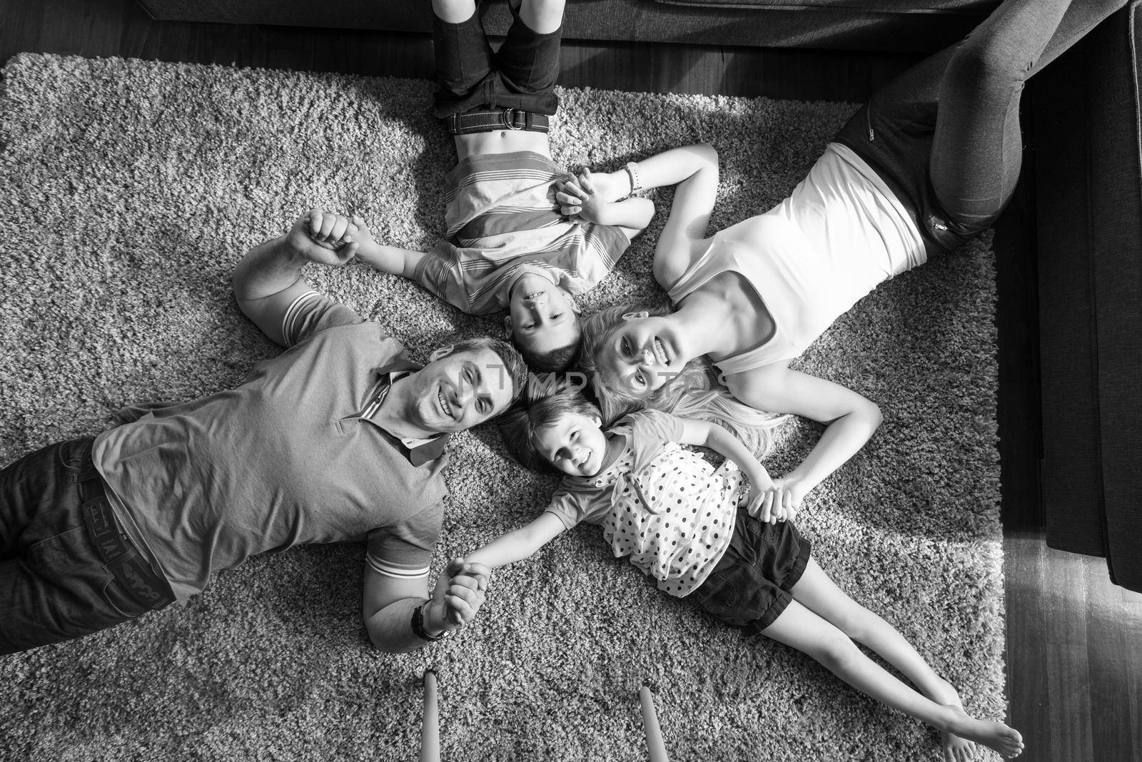 happy family lying on the floor by dotshock