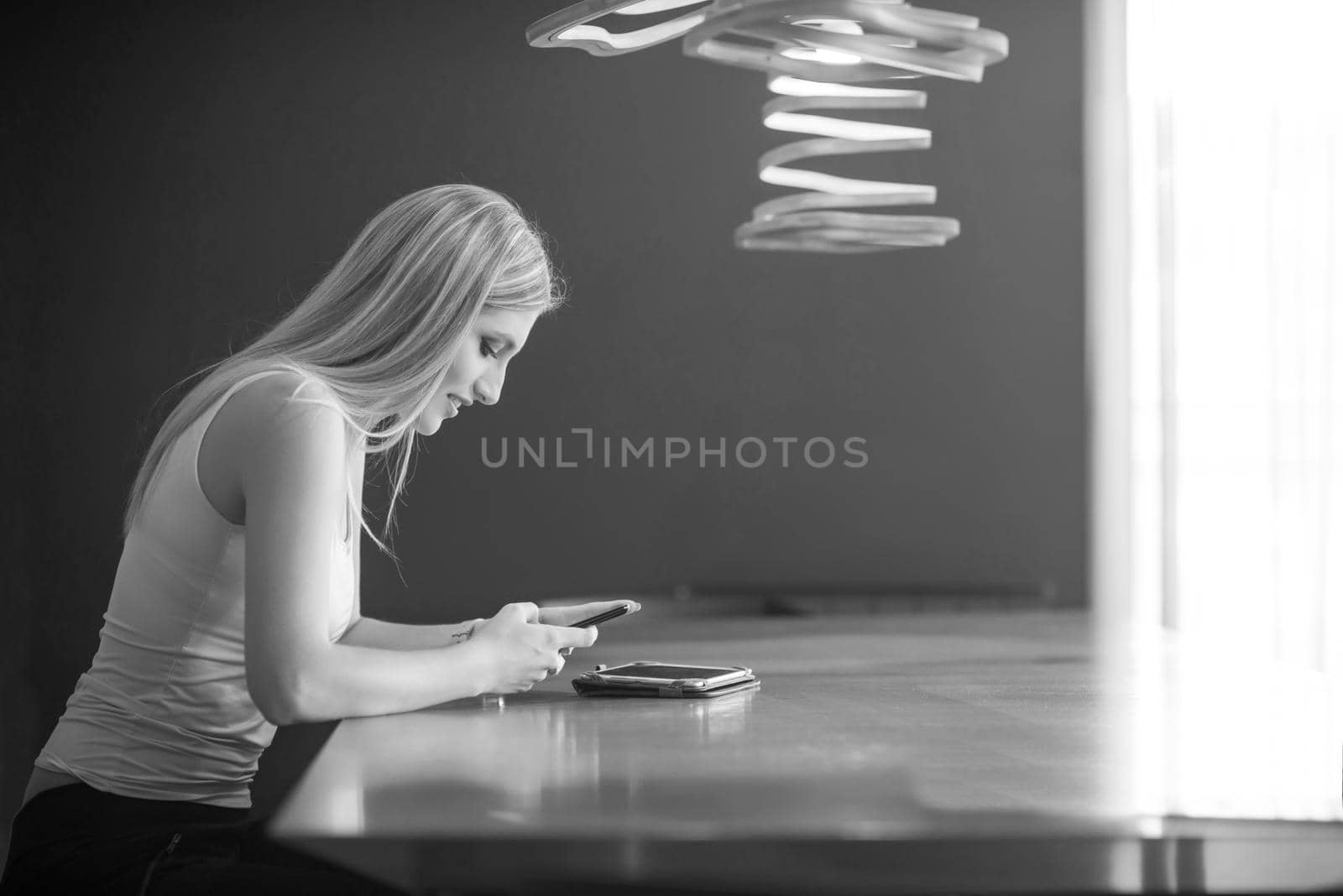 young woman using mobile phone by dotshock