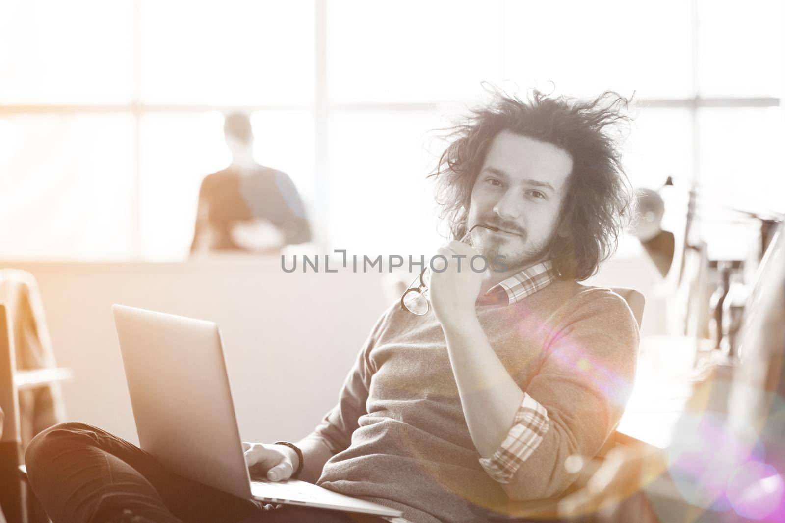 Young businessman using computer at work by dotshock