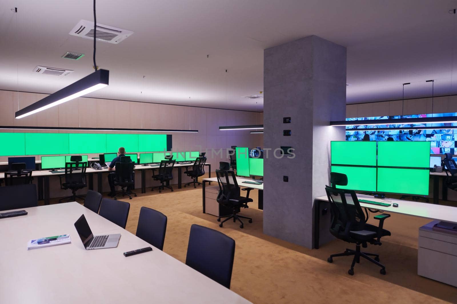 Group of Security data center operators working in a CCTV monitoring room looking on multiple monitors  Officers Monitoring Multiple Screens for Suspicious Activities  Team working on the System Control Room