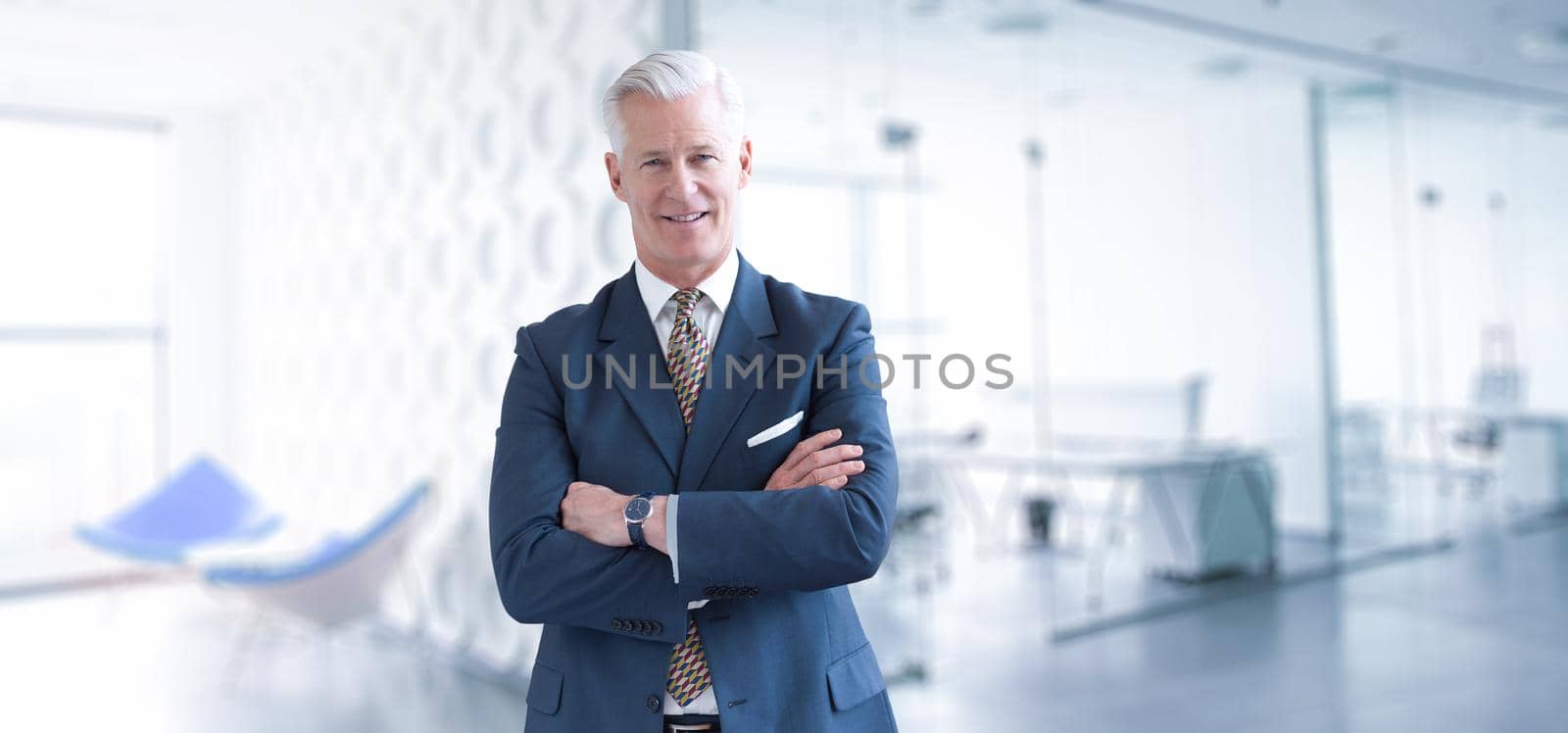 Portrait of senior businessman in front of his modern office