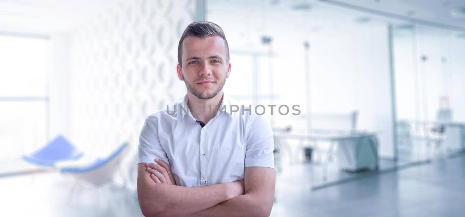 Young businessman in his office by dotshock