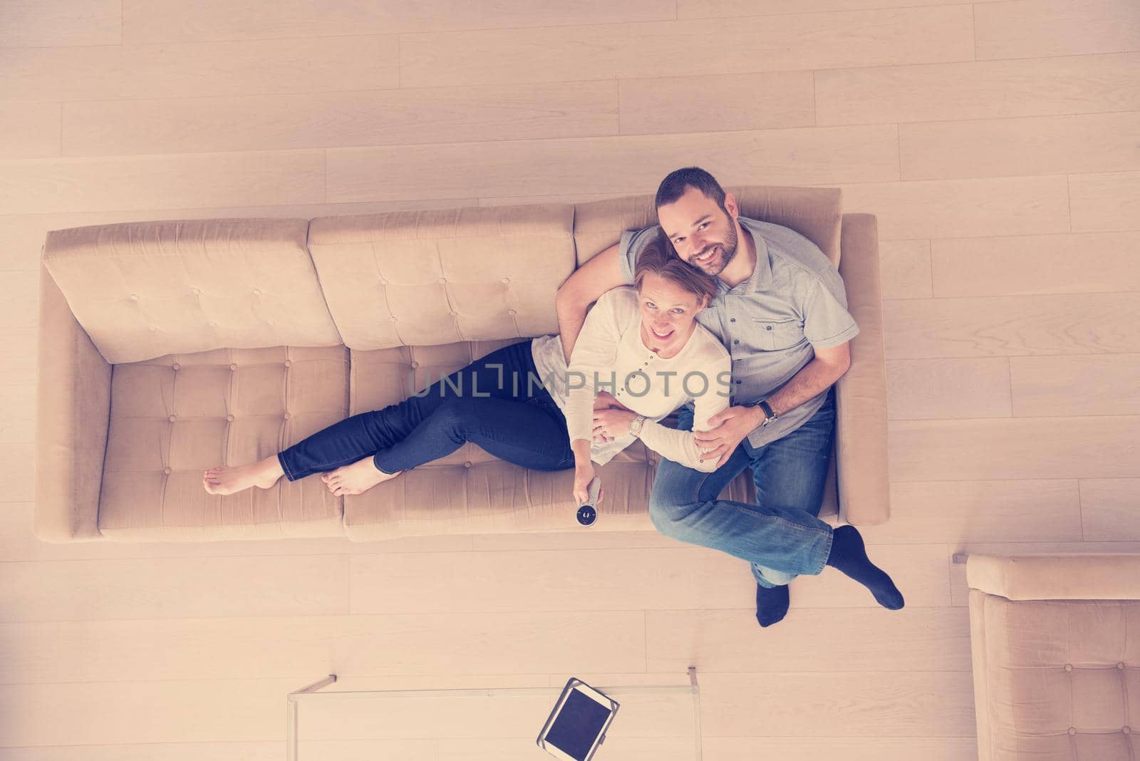 romantic couple on the sofa watching television top view by dotshock