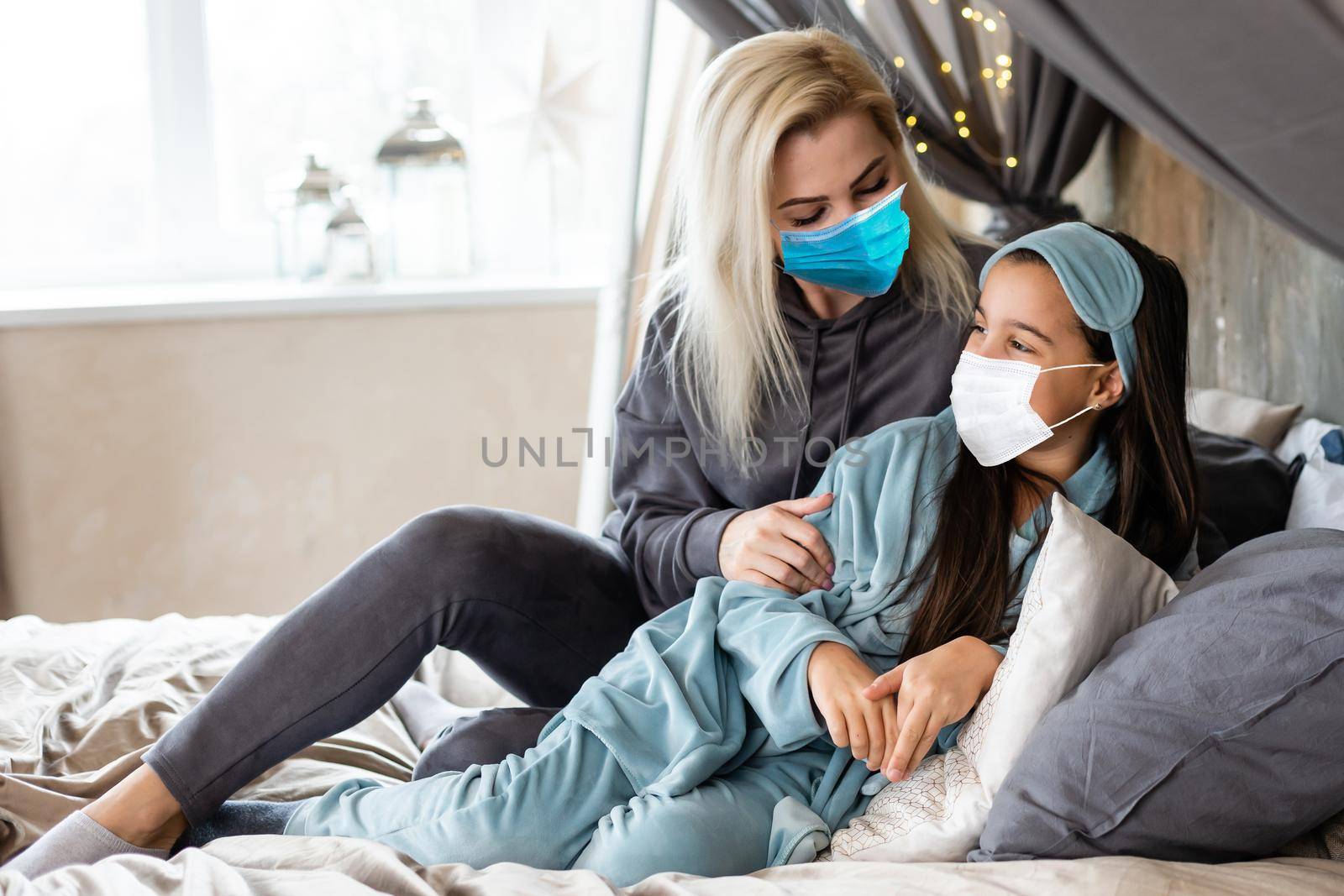 Mother and daughter in medical face mask Christmas concept.