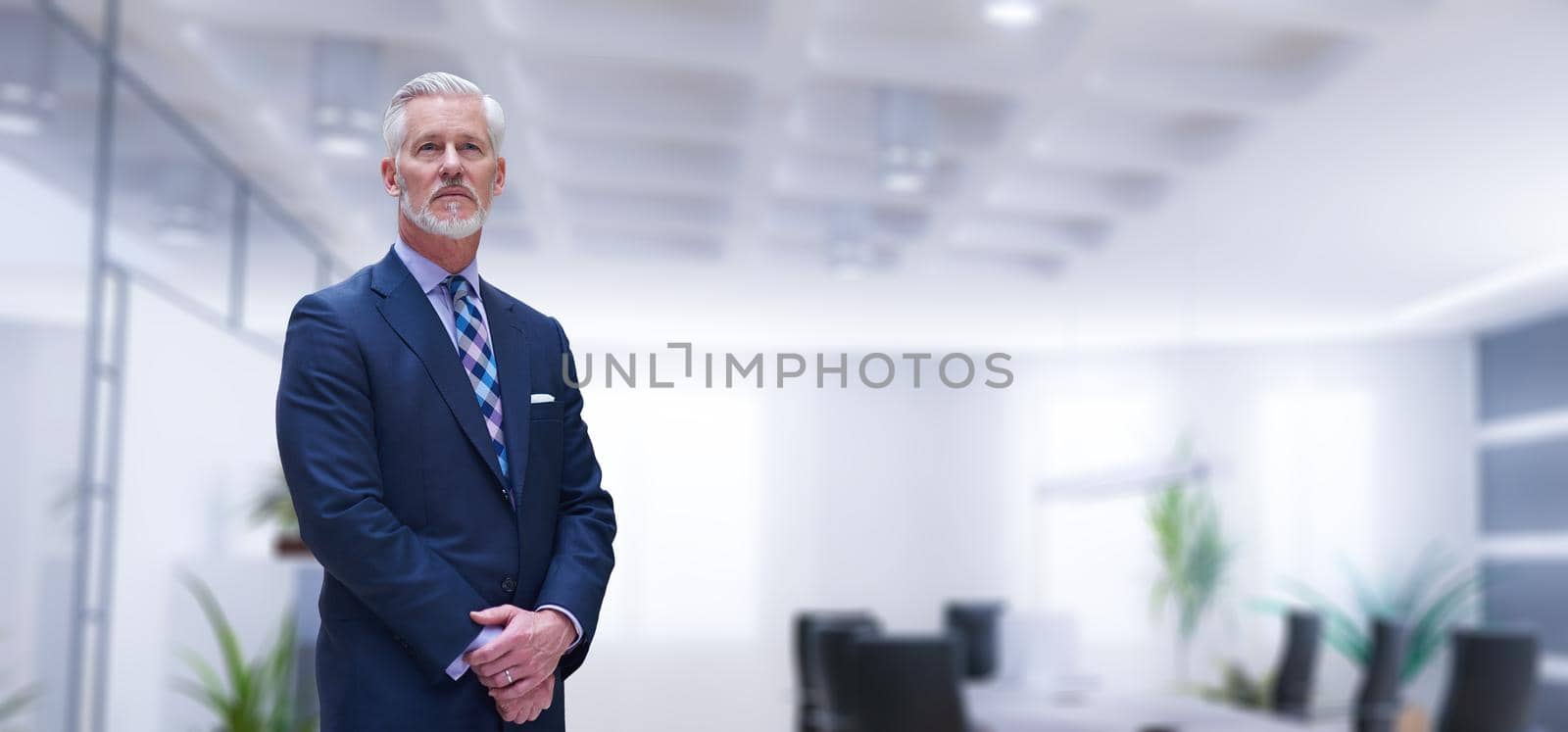 Portrait of senior businessman in front of his modern office