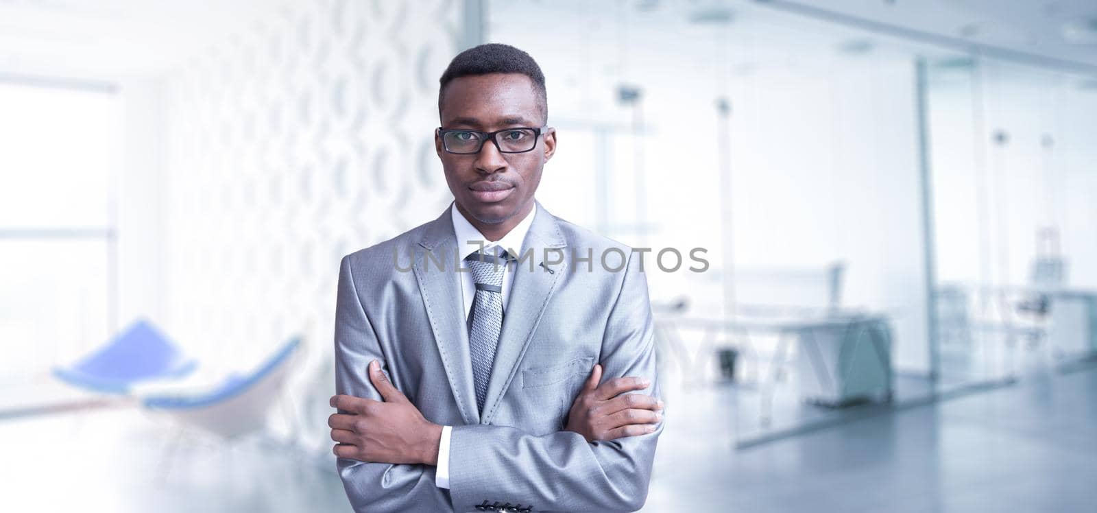 Portrait of young junior businessman in front of his big modern office