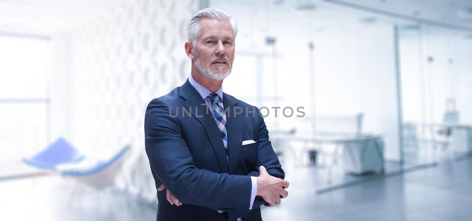 Portrait of senior businessman in front of his modern office