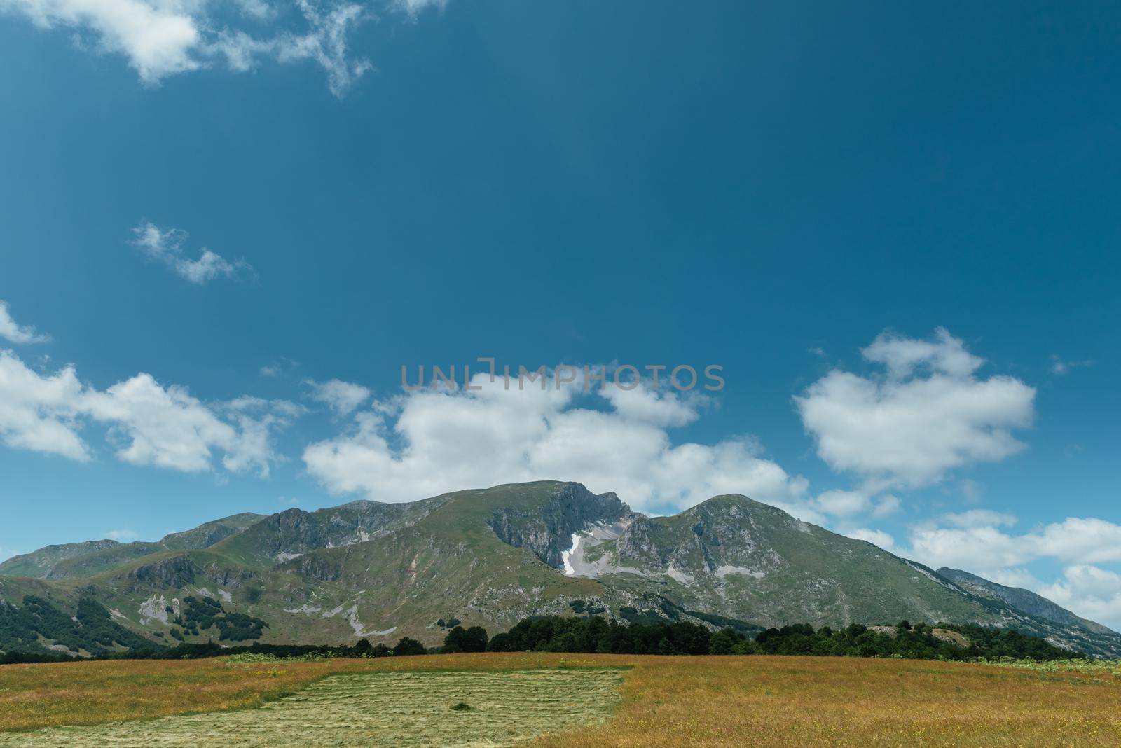 Amaizing view on Durmitor mountains, National Park, Mediterranean, Montenegro, Balkans, Europe. Bright summer view from Sedlo pass. The road near the house in the mountains. by Andrii_Ko