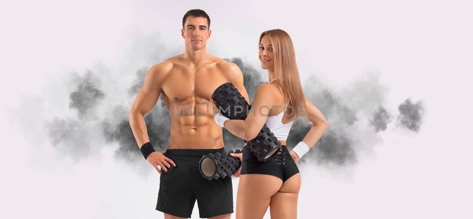 Fit couple at the gym isolated on white background. Fitness concept. Healthy life style. by MikeOrlov