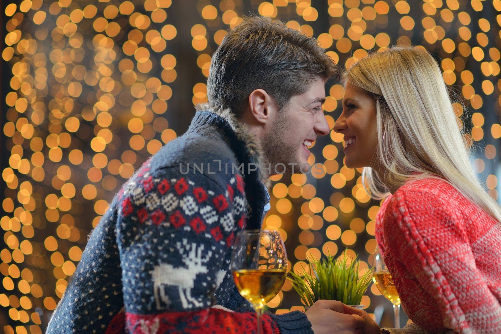 romantic evening date in restaurant  happy young couple with wine glass tea and cake