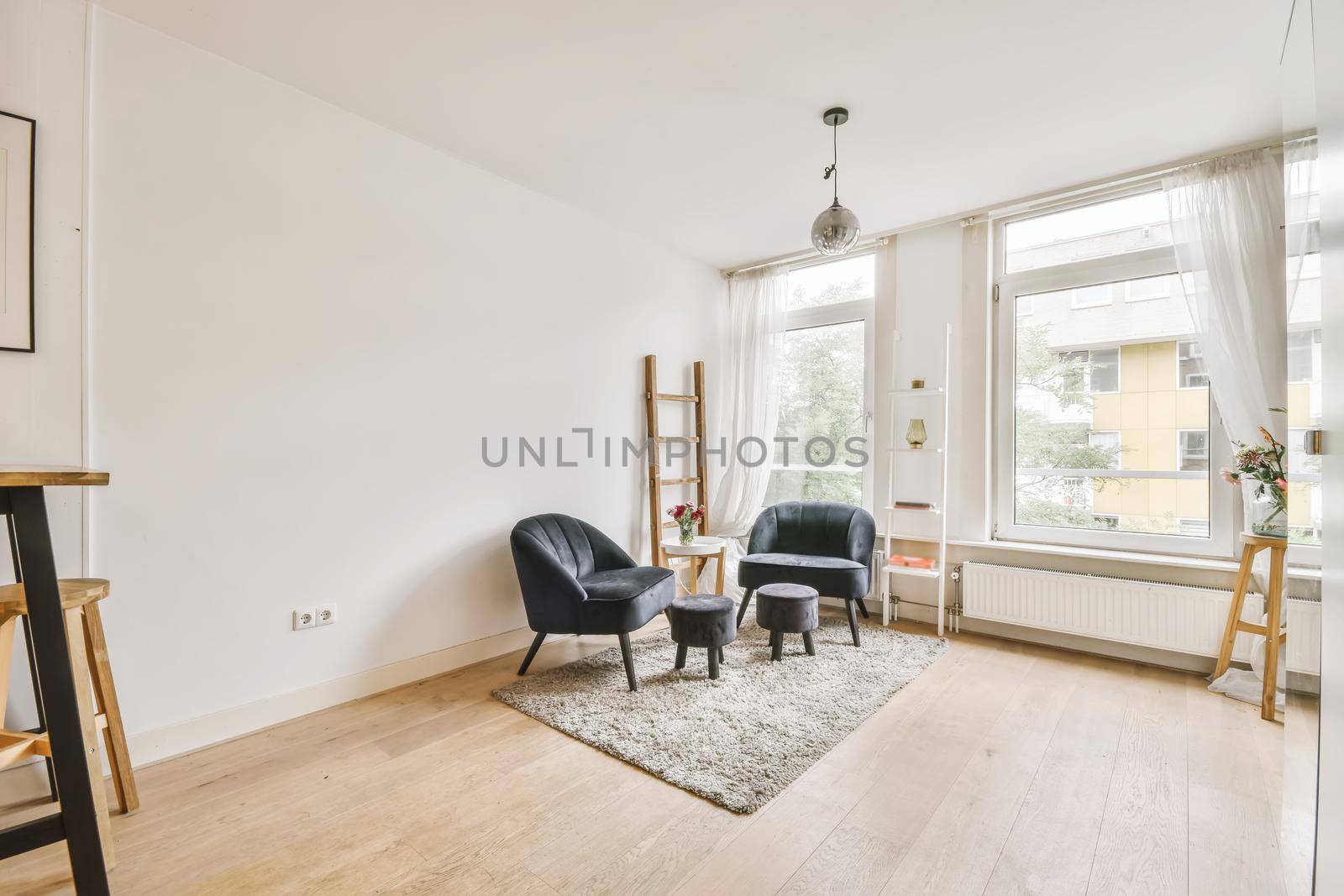 Corner of the studio apartment with comfortable velvet armchairs