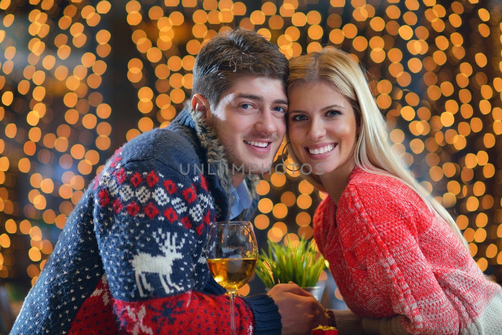 romantic evening date in restaurant  happy young couple with wine glass tea and cake