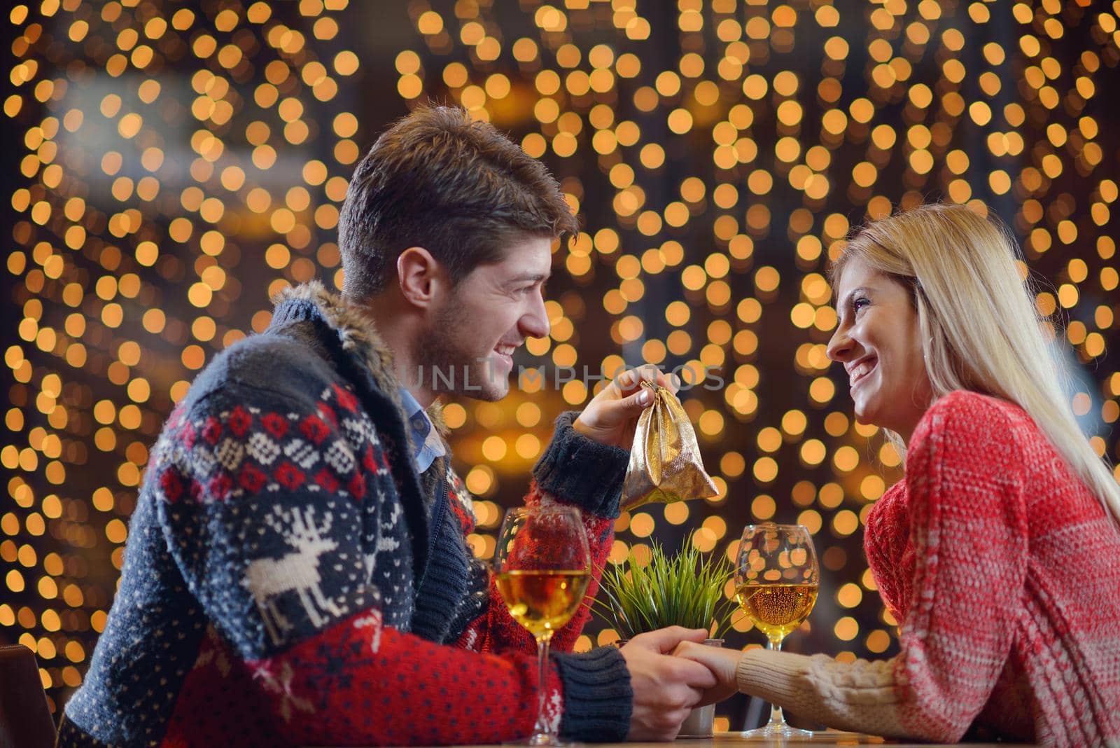 The young man gives a wedding ring   gift to  girl in restaurant