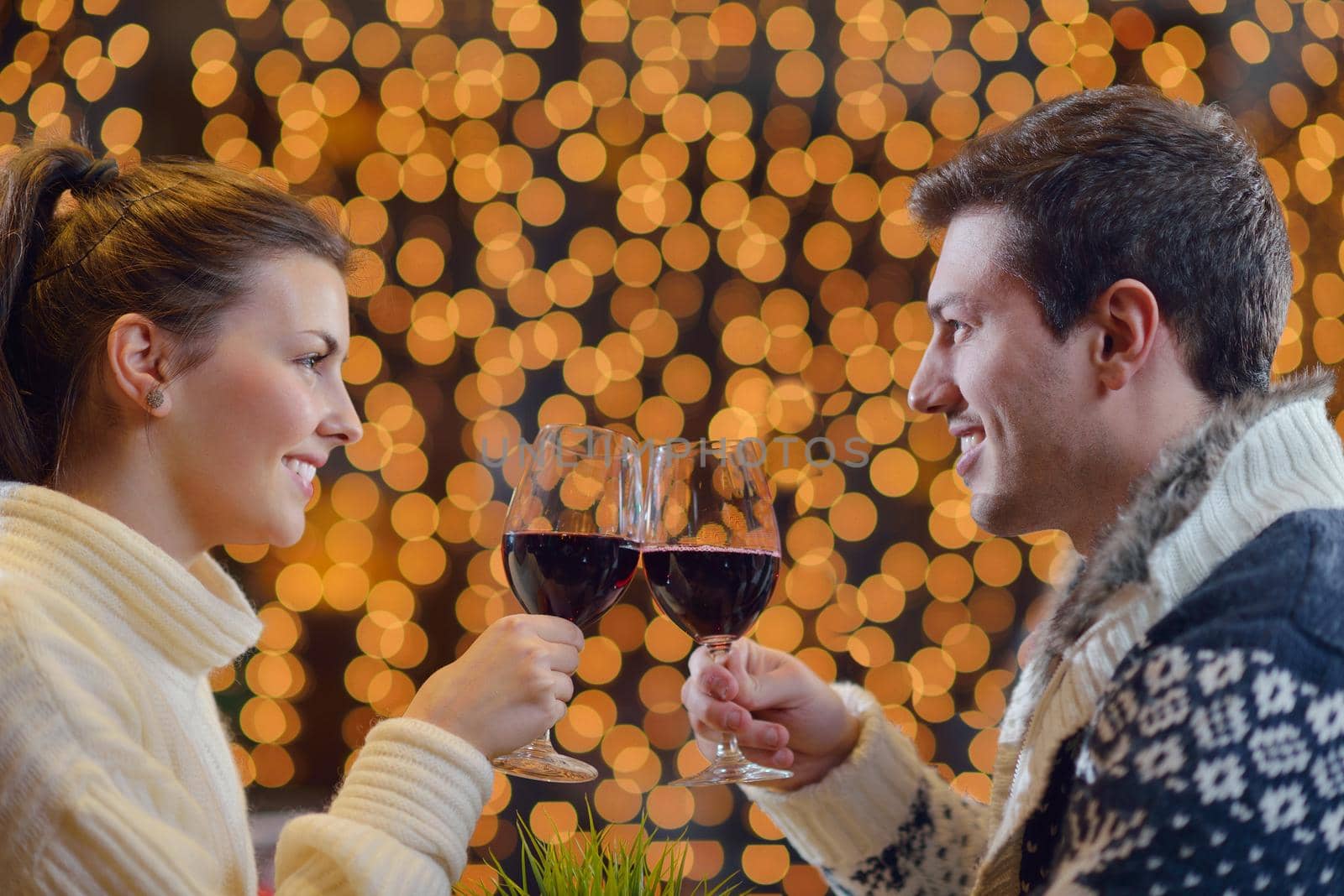 romantic evening date in restaurant  happy young couple with wine glass tea and cake