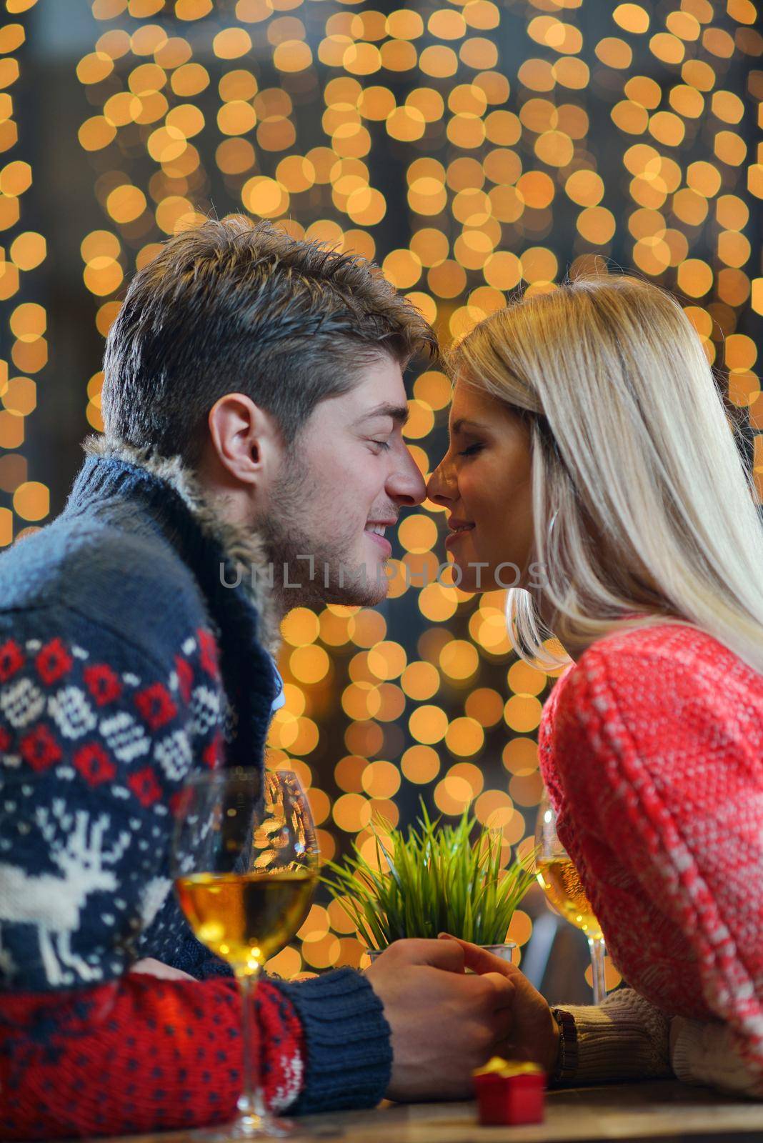 romantic evening date in restaurant  happy young couple with wine glass tea and cake