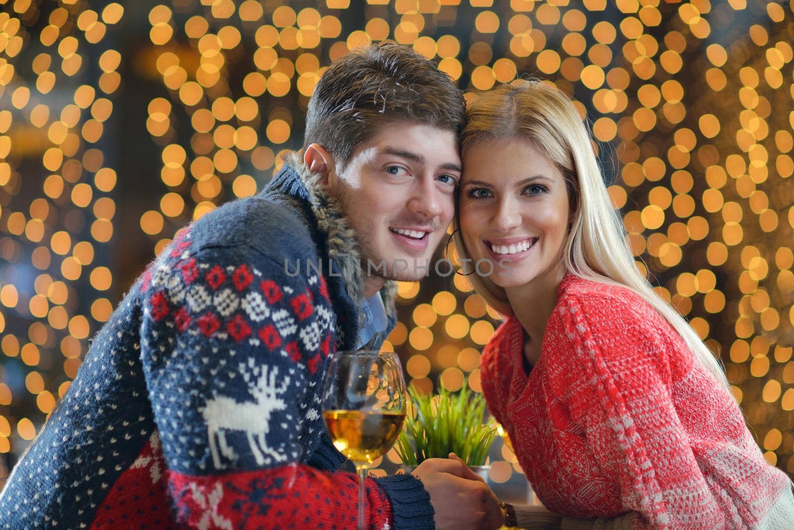 romantic evening date in restaurant  happy young couple with wine glass tea and cake